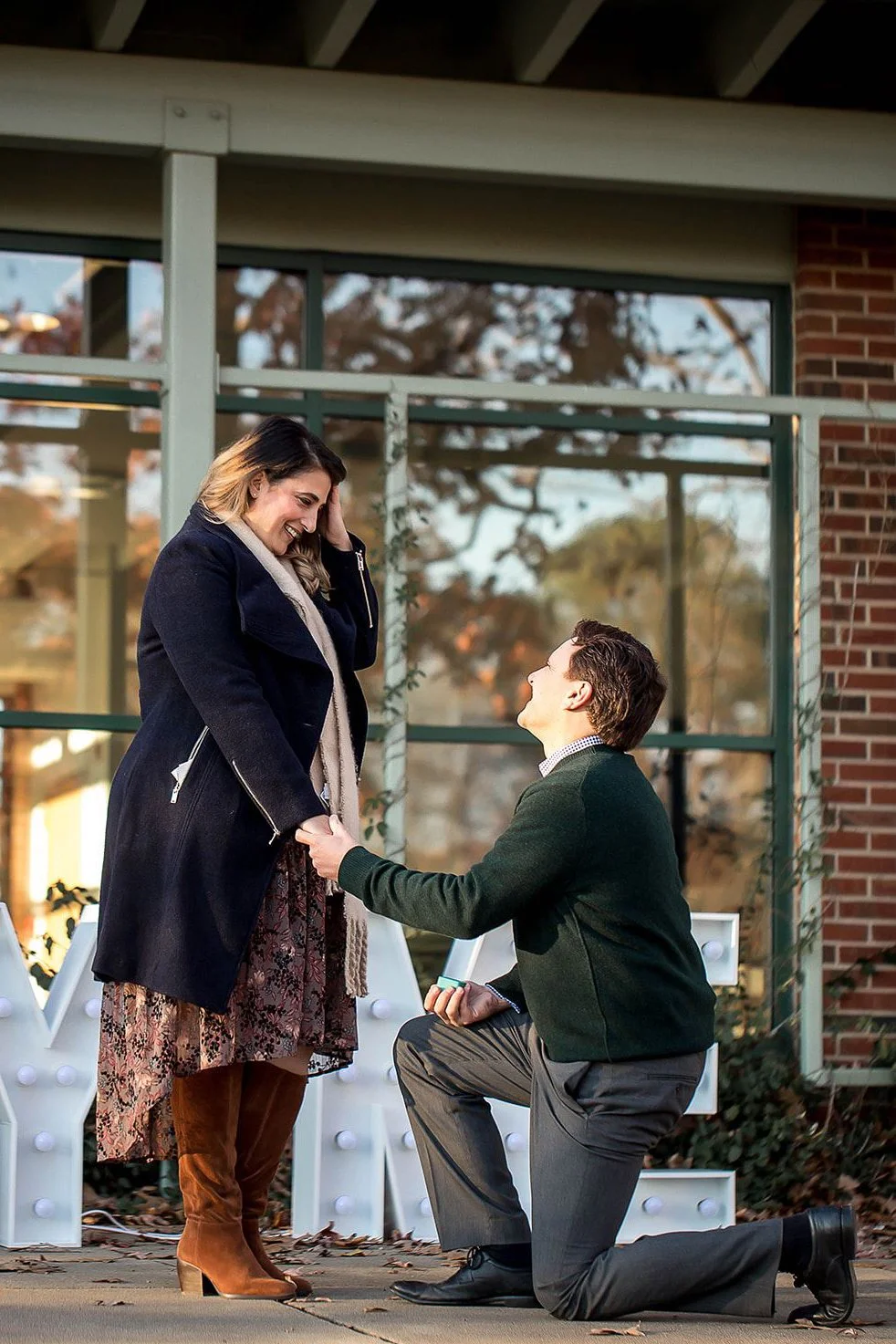 man proposes to girlfriend during outdoor winter surprise proposal at freedom park in charlotte nc