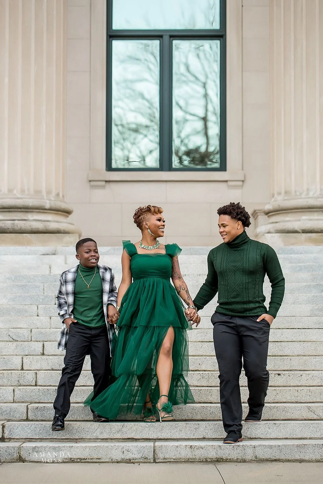 mother and sons hold hands and walk down stairs of federal court building in charlotte nc