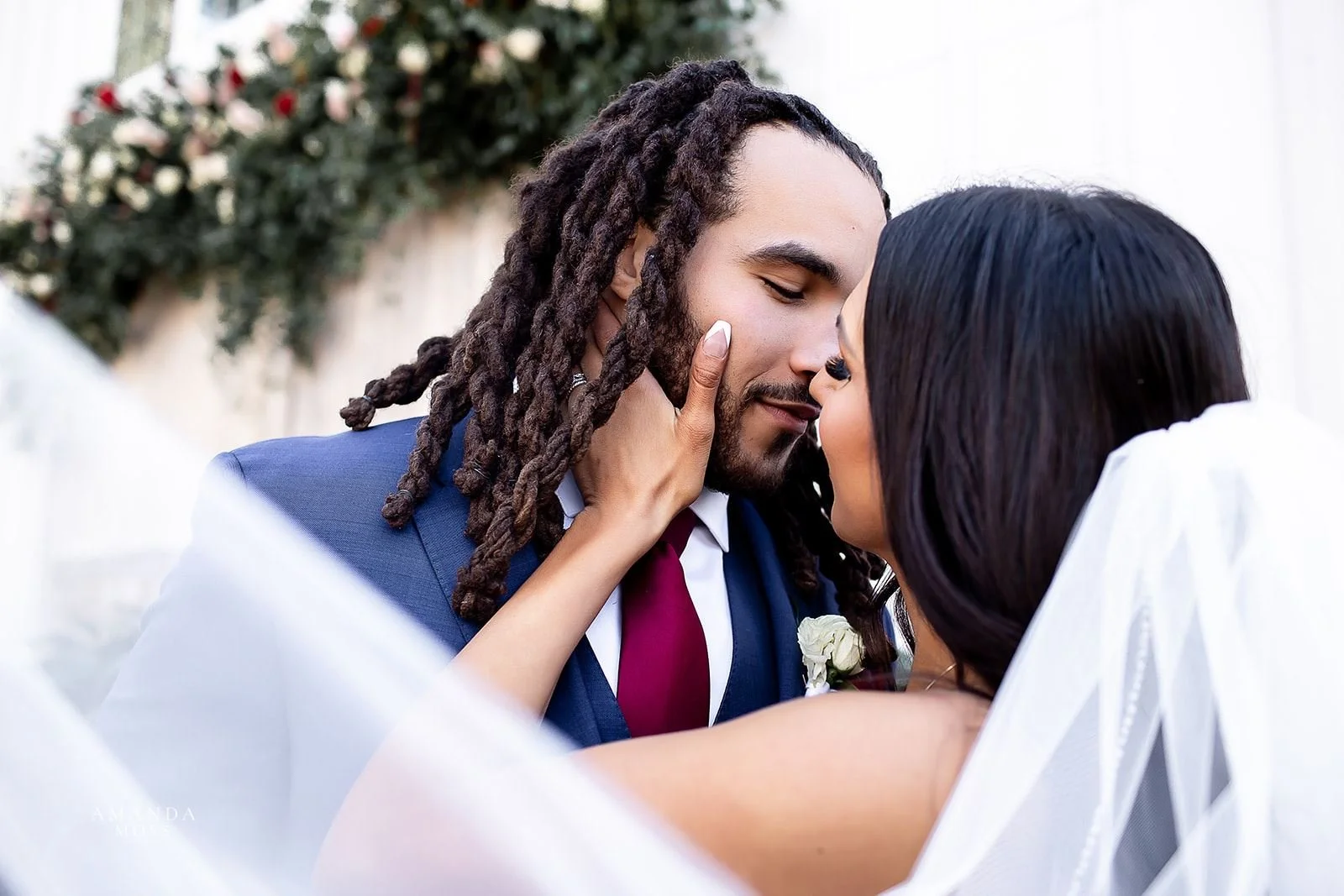 close up of bride and groom kissing with the veil in the foreground at barn of chapel hill