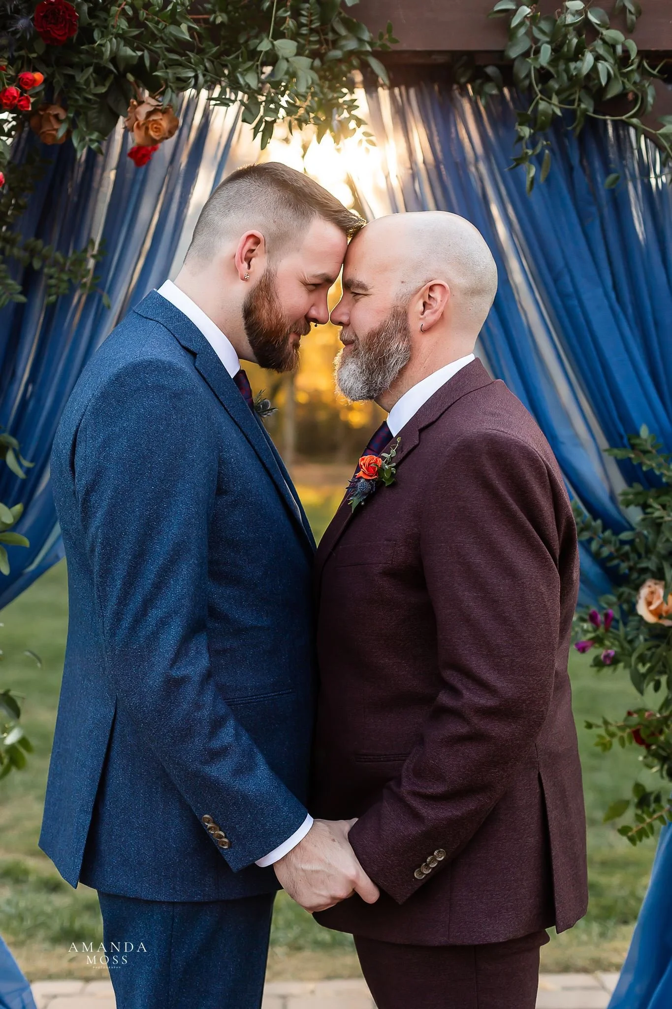 portrait of two grooms at outdoor wedding ceremony at providence cotton mill in maiden nc