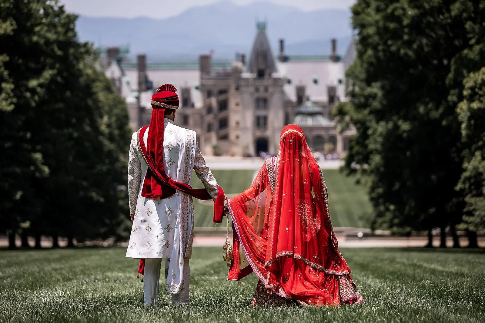 Indian wedding couple holds hands and looks off into distance at Biltmore Estate