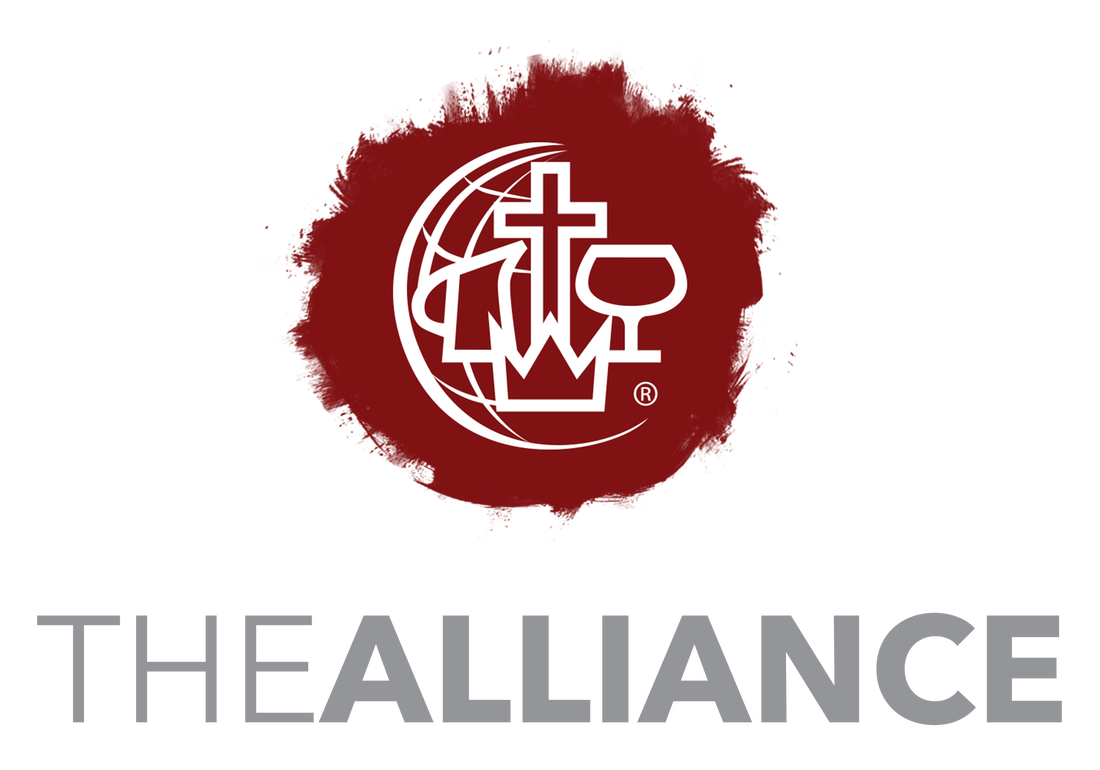A logo with a red splatter background featuring a globe, a cross, a Bible, and a chalice, with the words 'THE ALLIANCE' underneath.
