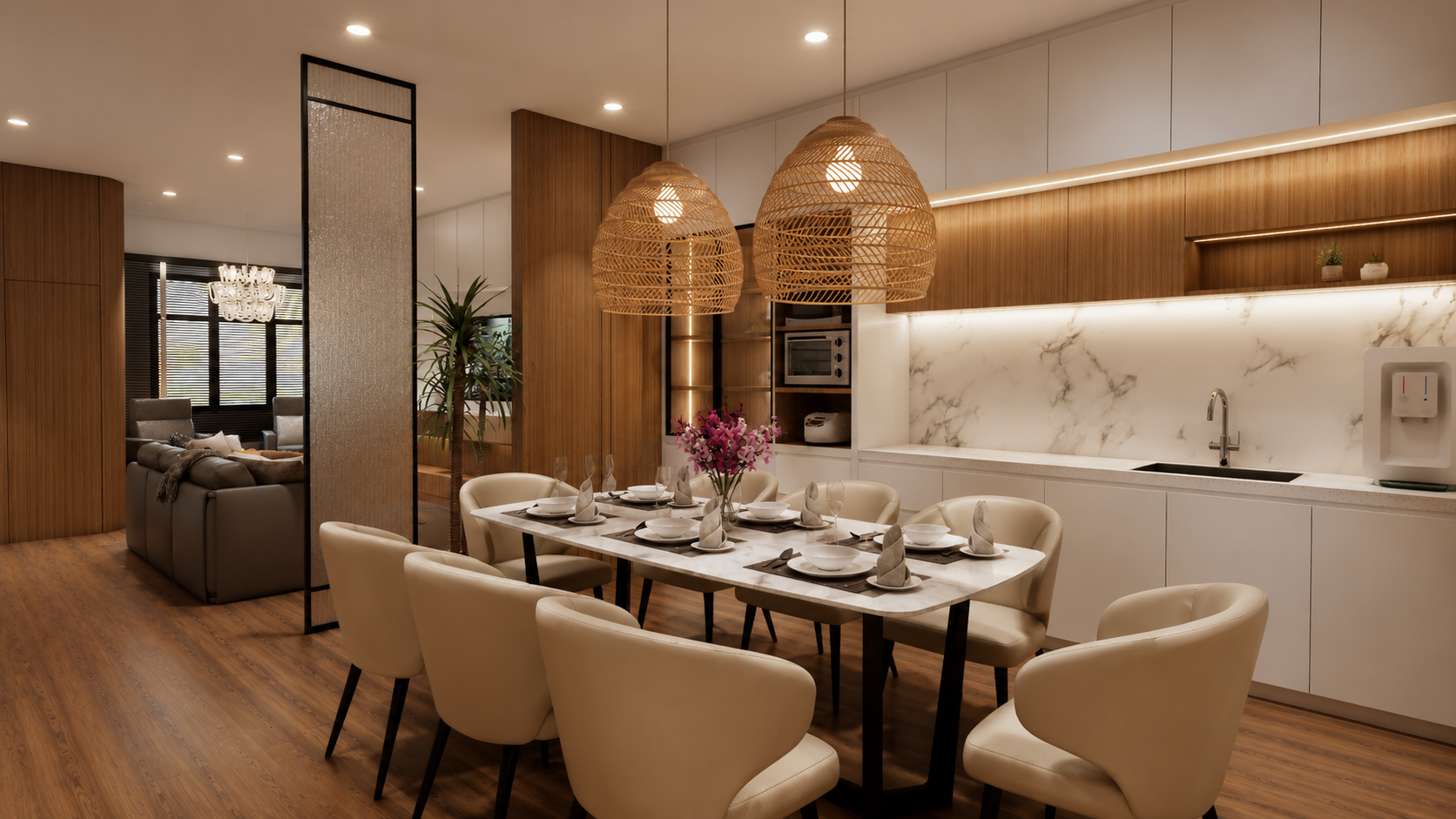 Modern dining area with a marble-top table set with white dinnerware and napkins, surrounded by cream-colored chairs, and decorated with a pink floral centerpiece and two woven pendant lights, adjacent to a sleek kitchen with white cabinets and marble backsplash.