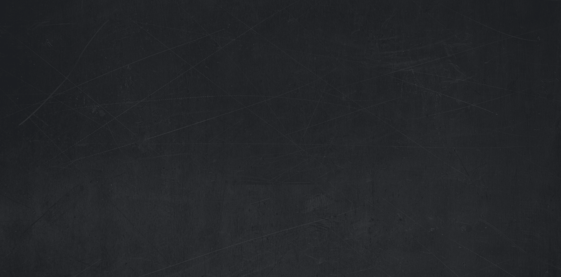A blank black chalkboard with scratches and marks.
