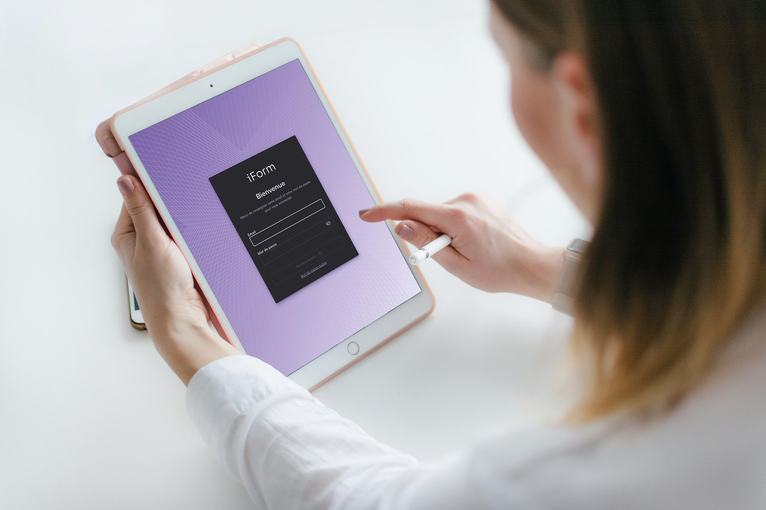 Person holding an iPad with a purple background and a login screen for 'iForm' app, in white long-sleeve shirt, using stylus.