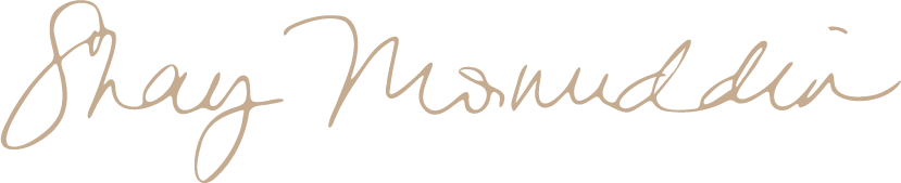 Signature of the name 'Shay Musmudi' in cursive handwriting.