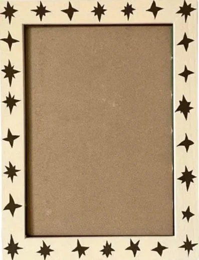Beige picture frame with black stars around the border and a plain inner area.