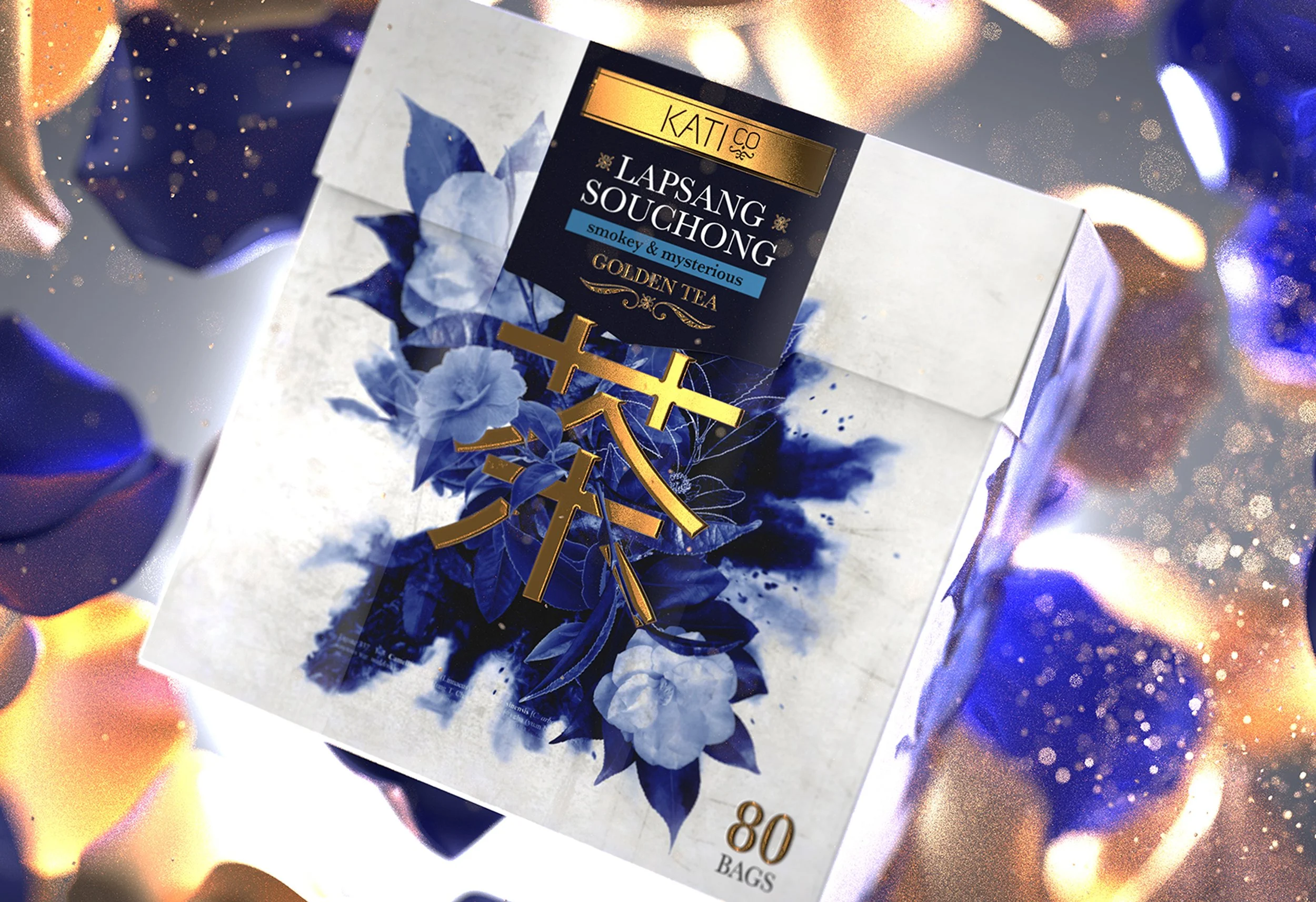 A box of Kati Co Lapsang Souchong tea with a blue floral design and gold accents, labeled as smoky and mysterious, containing 80 tea bags, placed on a colorful, glowing background.