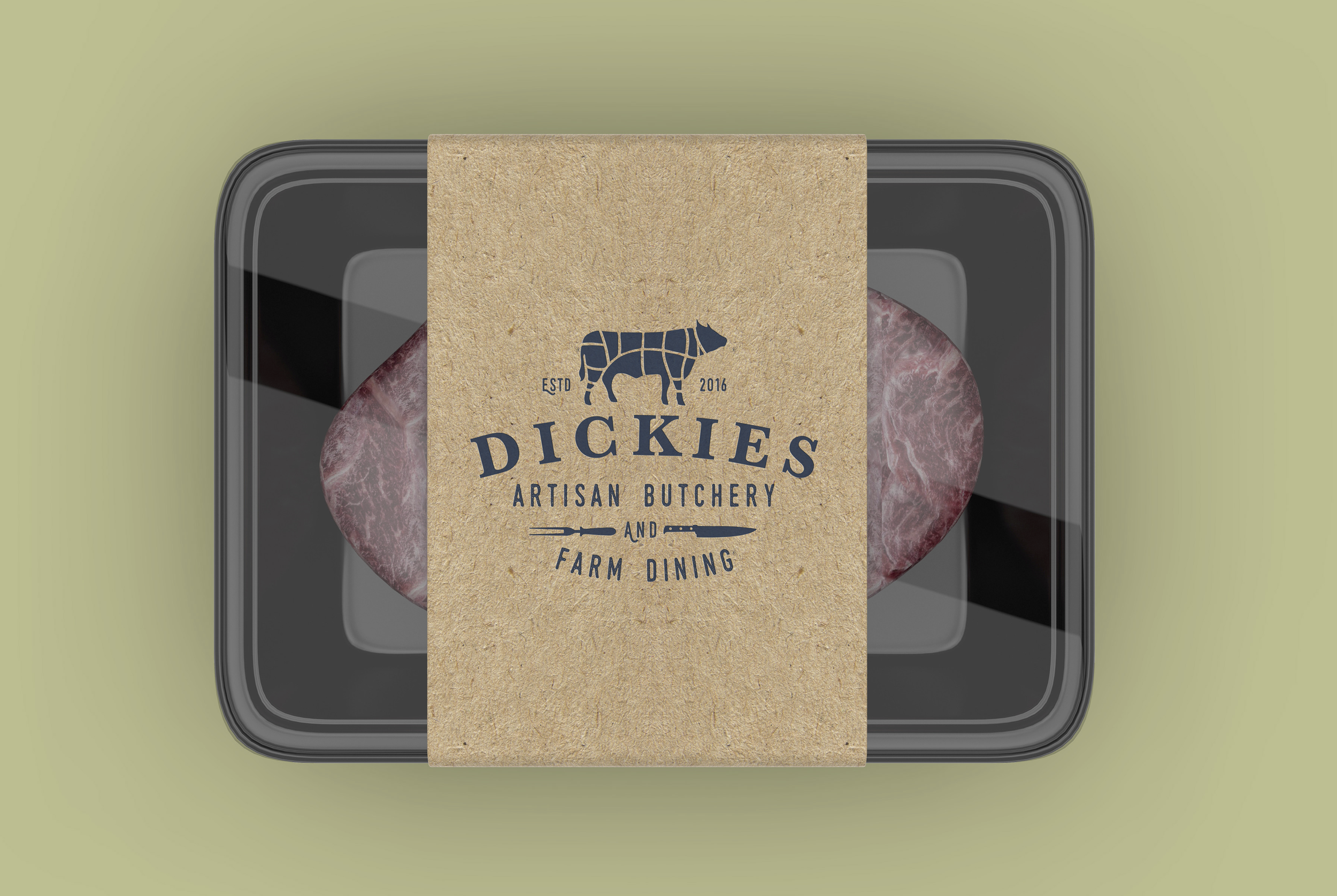 Packaging of raw meat with a Kraft paper label from Dickie's artisan butchery, showing a cow logo and farm-to-table message.
