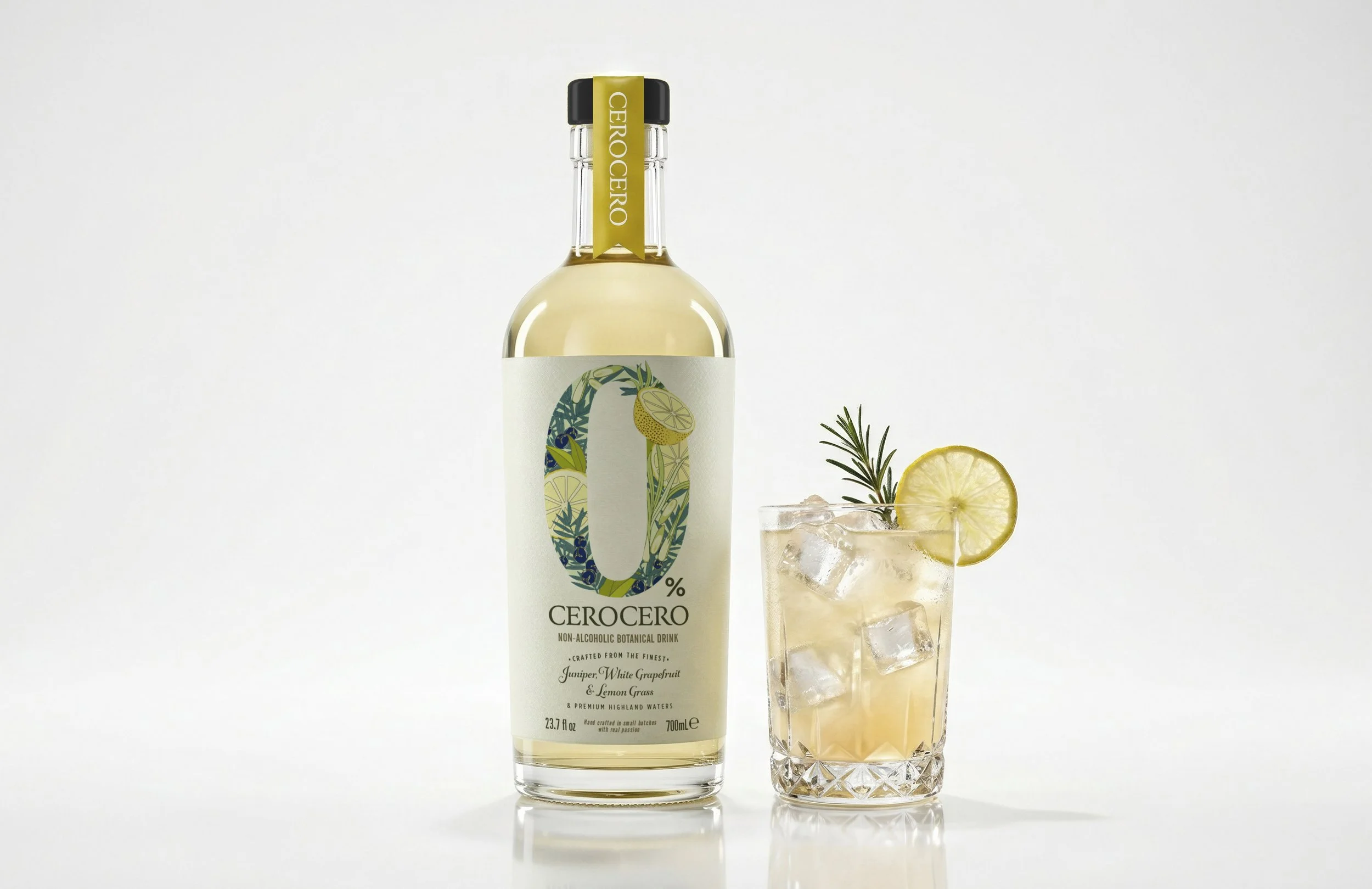 A bottle of Cerocero non-alcoholic botanical drink next to a glass filled with ice, garnished with a lemon slice and sprigs of rosemary, with a plain white background.