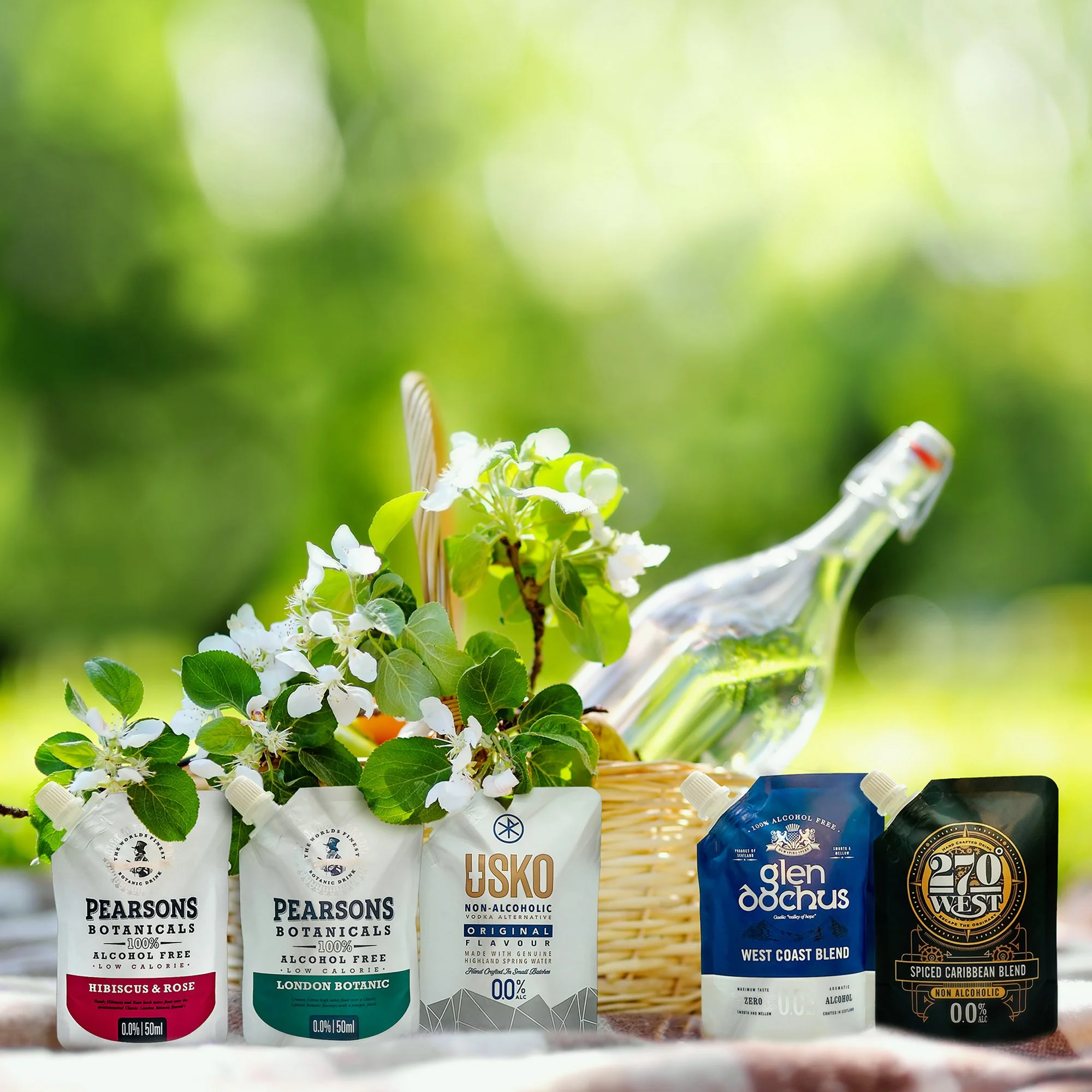 Assorted non-alcoholic craft beverages in pouches with black, white, green, and blue labels, including Pearsons Botanicals Hibiscus & Rose, London Botanic, No Suko vodka alternative, Glen Ochus West Coast blend, and 20 West Spiced Caribbean blend, se