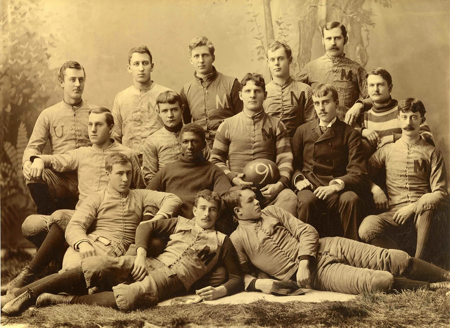 Historic University of Michigan football team photograph from the early 1890s. George Jewett is seated near the center wearing a dark sweater among his teammates.