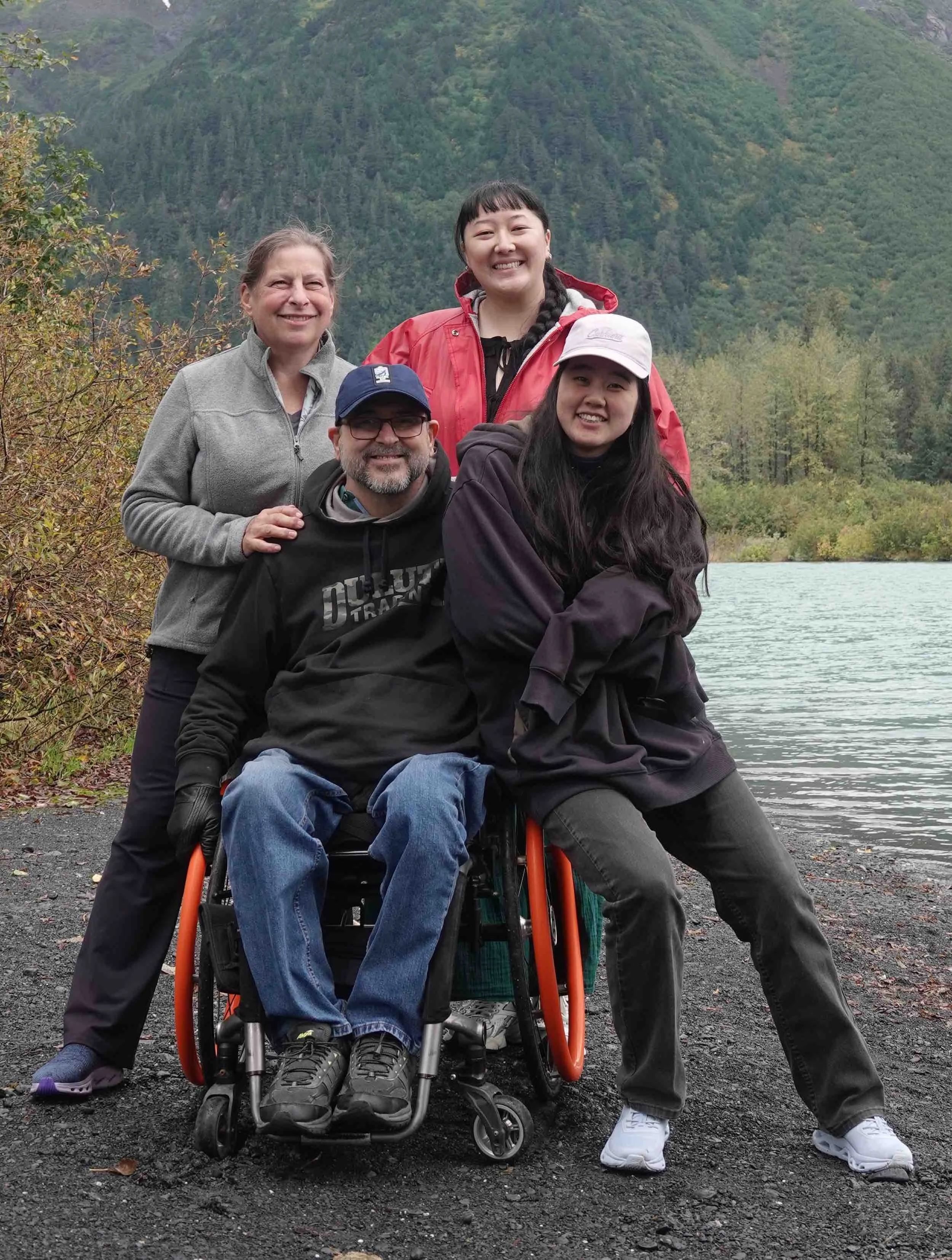 Mike Shultz smiles with his family beside a mountain lake, celebrating faith, hope, and the enduring power of love.