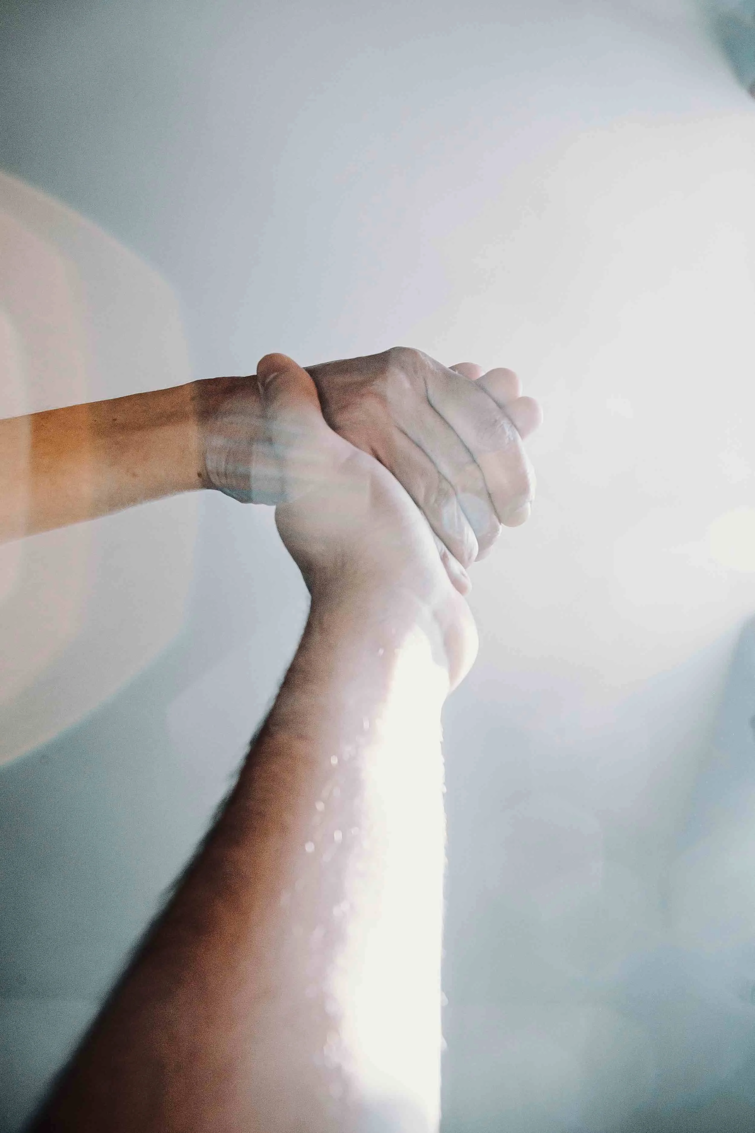 Two hands clasped together in a gesture of support and encouragement, symbolizing hope, compassion, and the message of Mike Shultz's memoir You Can't Stop Love.
