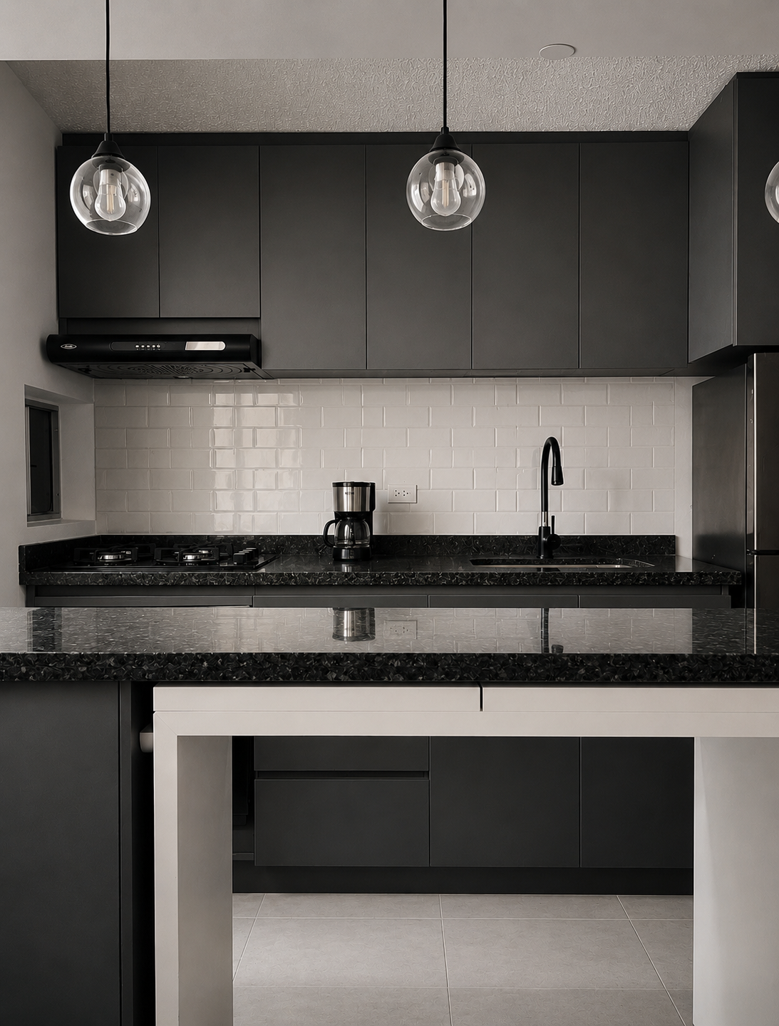 Modern kitchen with black cabinets, white subway tile backsplash, black countertops, and pendant lighting