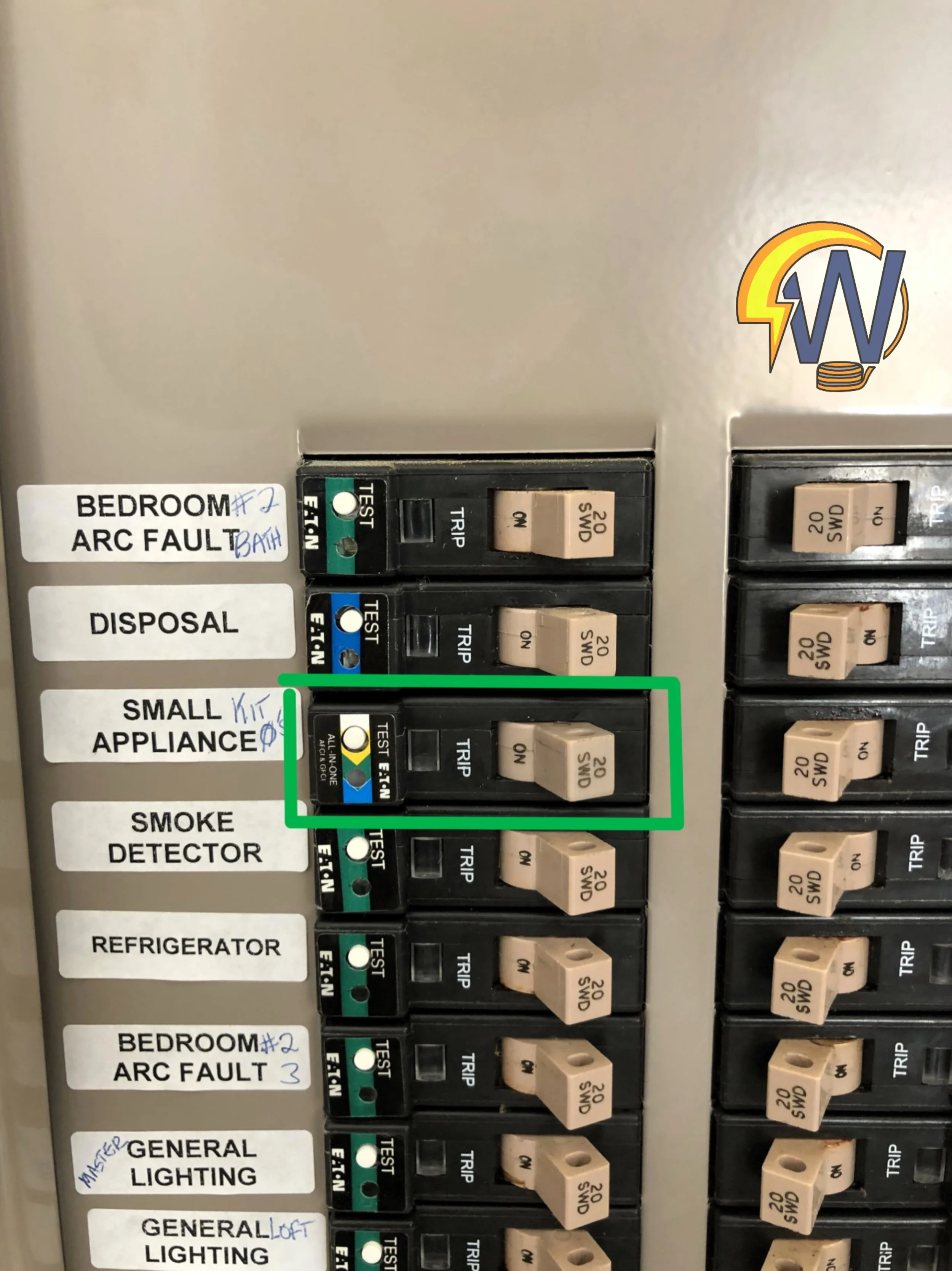 A collection of circuit breakers in an electrical panel, labeled for different rooms and purposes, including bedroom, disposal, small appliances, smoke detector, refrigerator, and general lighting. The circuit breakers are beige and black, with some 