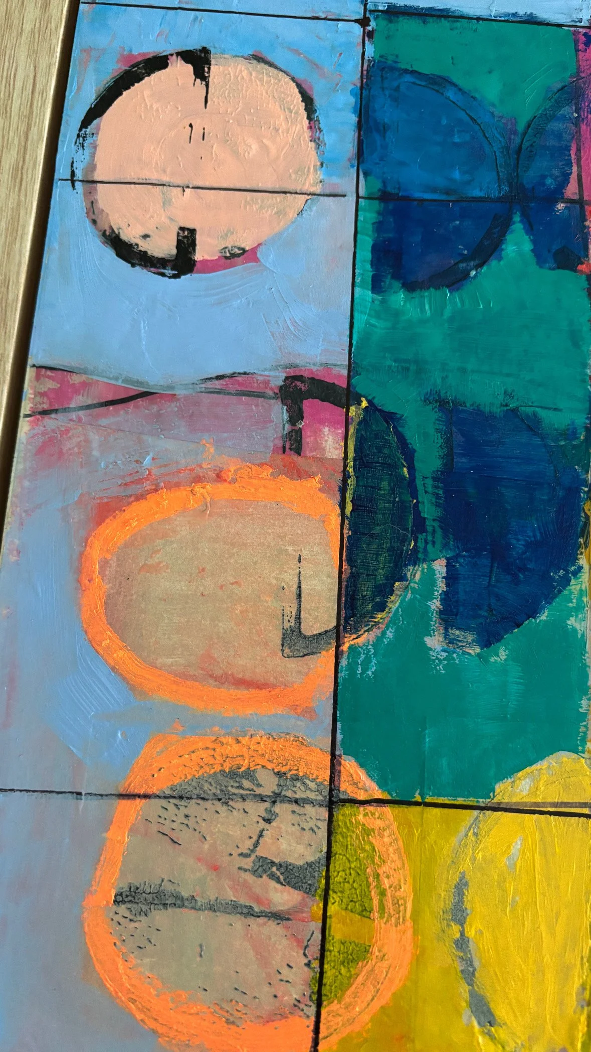 Abstract painting with four sections, each featuring a circular shape with bold outlines and vibrant background colors, including blue, pink, green, and yellow.