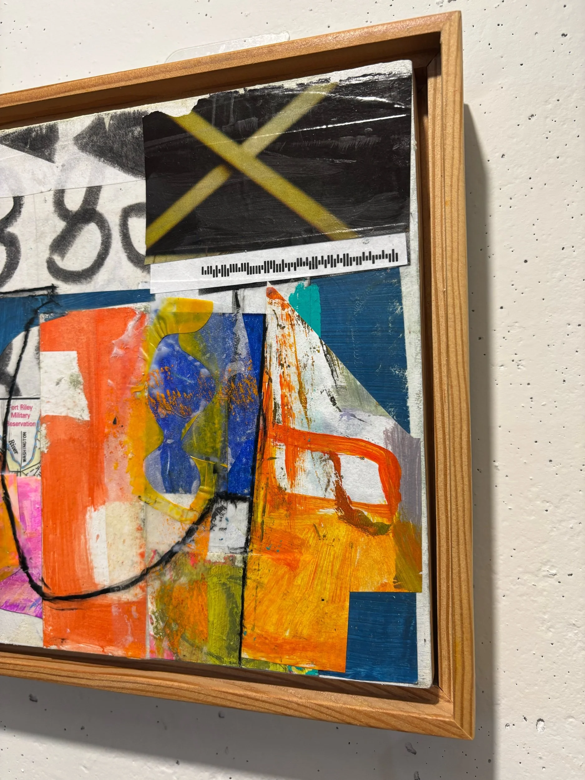 Close-up of colorful abstract artwork on a wooden-framed canvas.