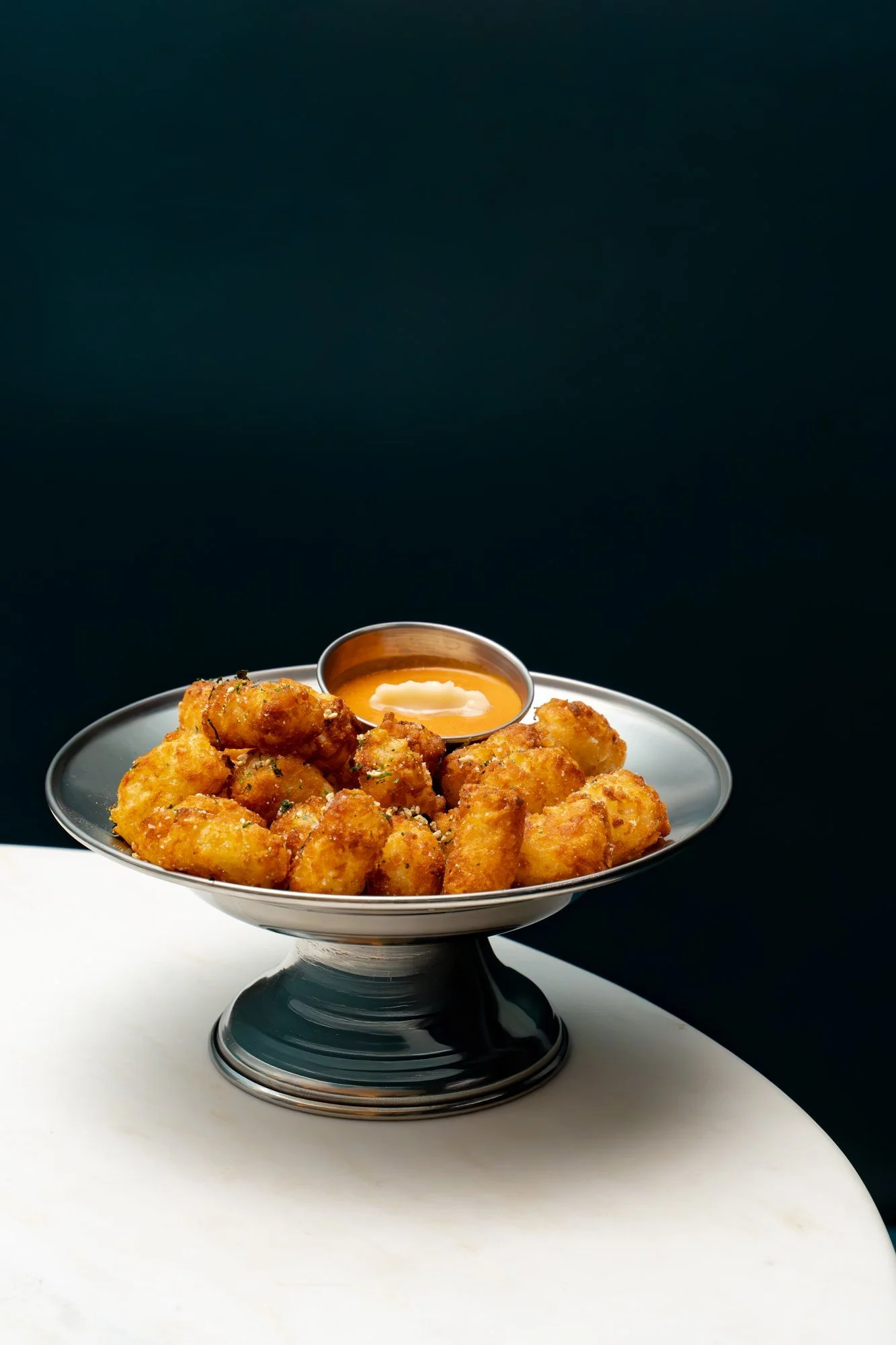 Silver bowl of crispy tater tots
