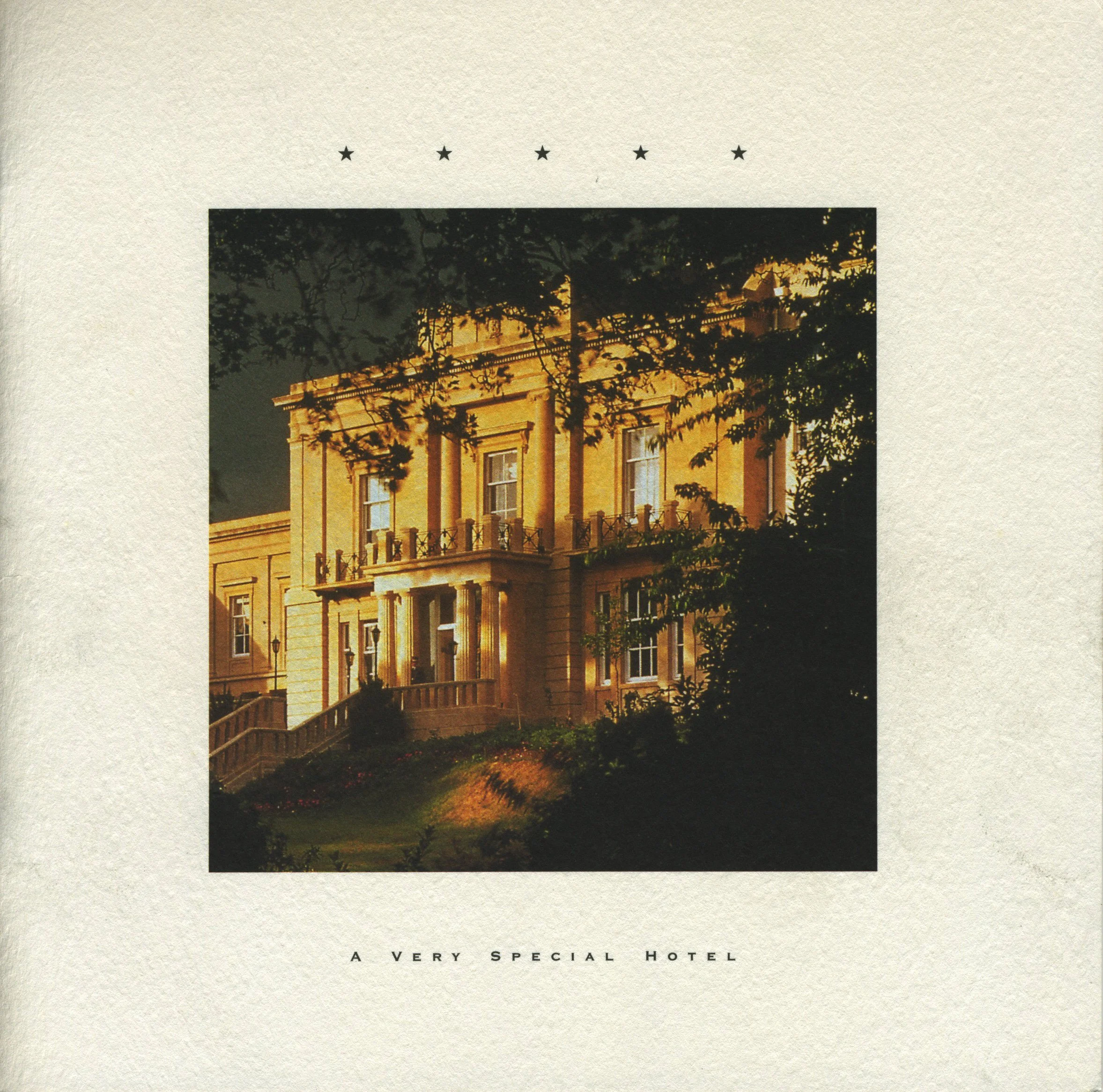 Front of a hotel with classical architecture illuminated at night, trees in the foreground, and the words "A Very Special Hotel" at the bottom.