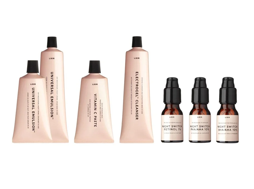 A collection of skincare and cosmetic bottles, including three LIXIR Night Switch bottles and three larger tubes labeled Universal Emulsion, Vitamin C Paste, and Electrogel Cleanser, arranged side by side against a white background.