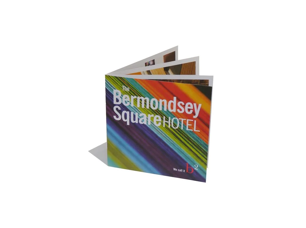 Colorful folded brochure advertising the Bermondsey Square Hotel with rainbow stripes and text.