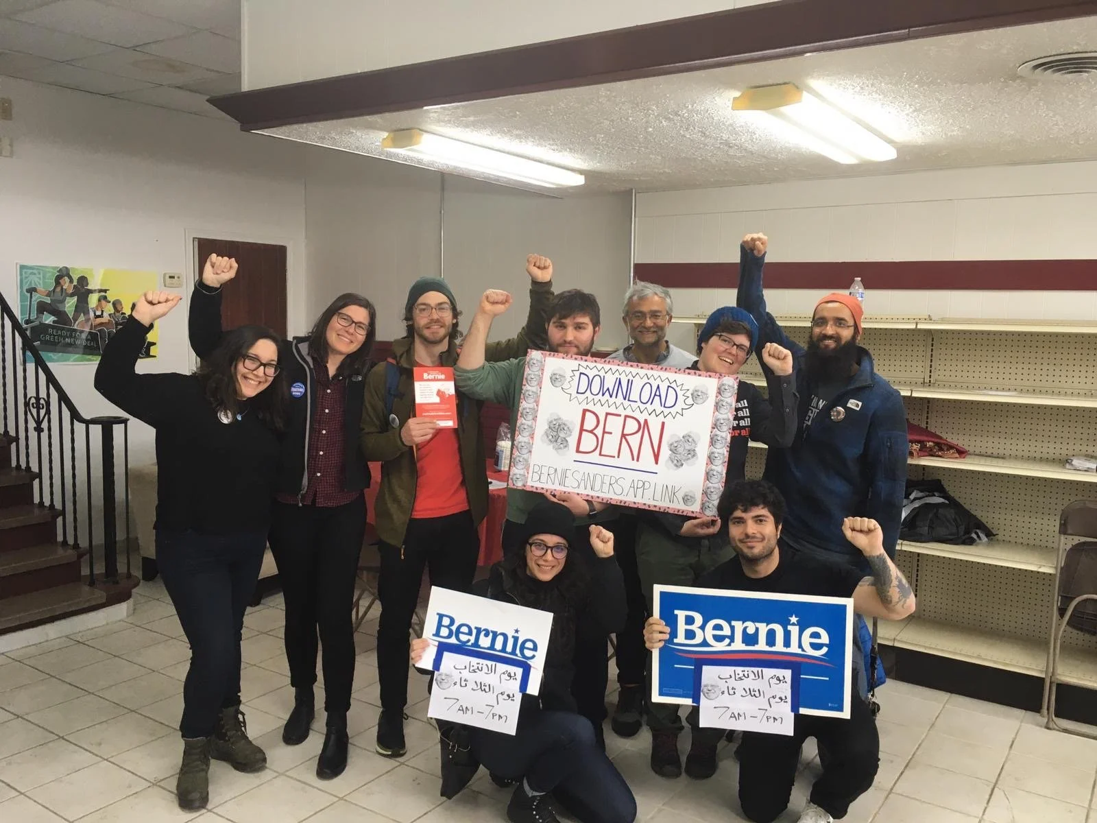 Jessica standing in a group of Bernie supporters, all with raised fists