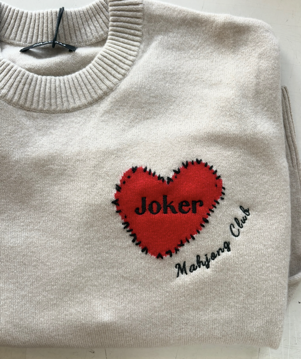 Cream-colored sweatshirt with a red heart patch and black embroidered text that reads 'Joker' inside the heart and 'Maharing Club' below it.