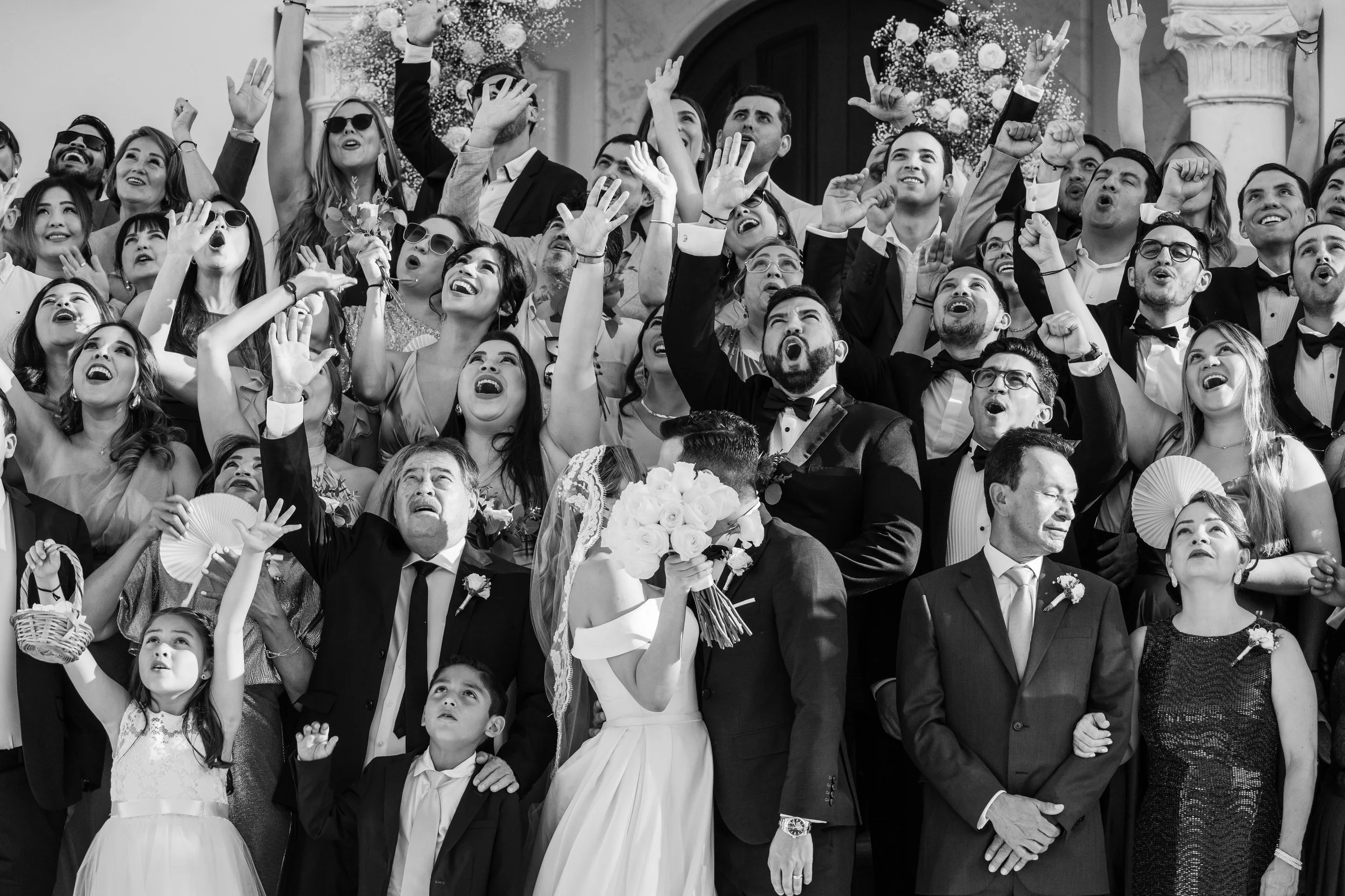 Candid group photo of a wedding group in black and white