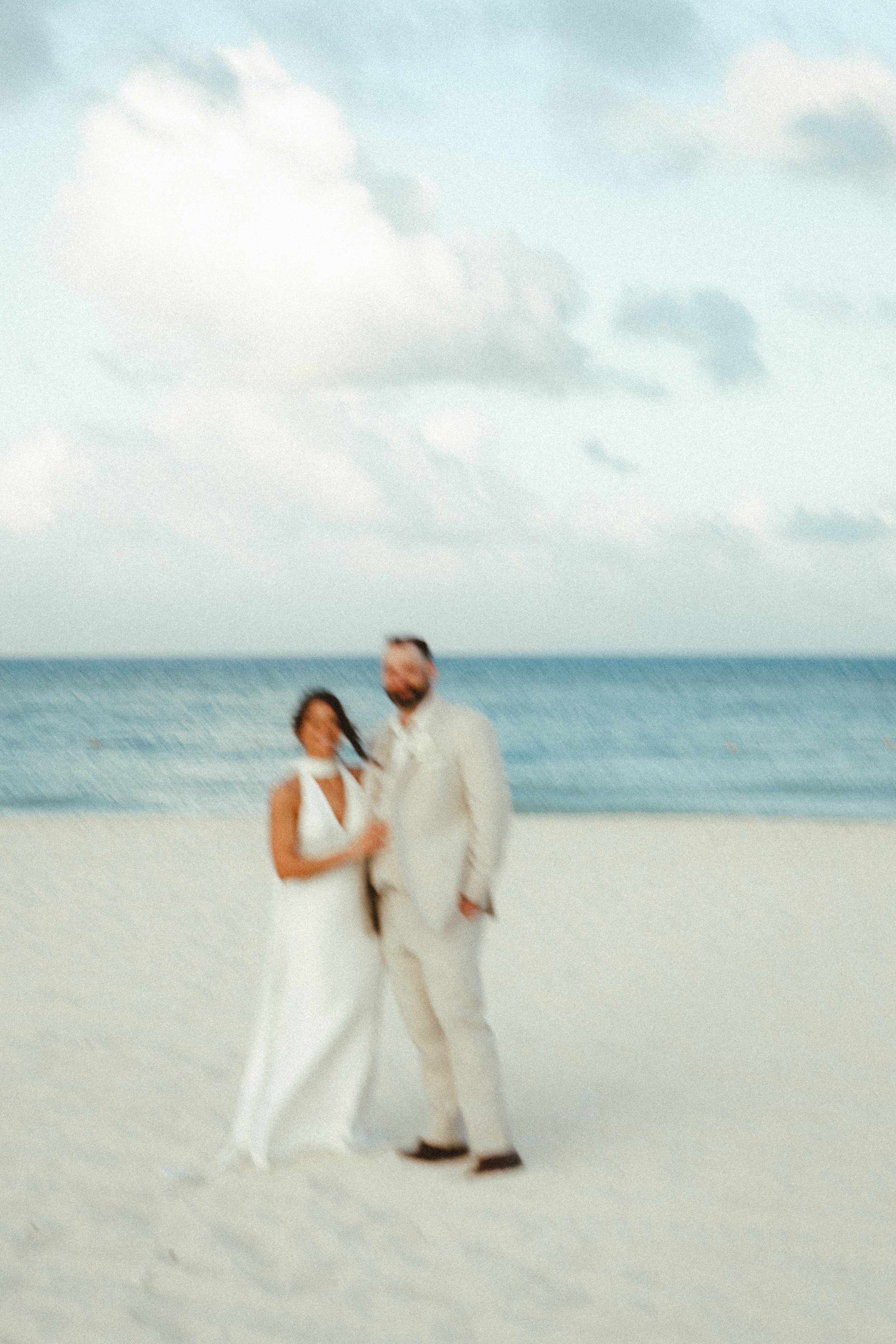 beach portrait of a bride and a groom standing in the beach in Mexico