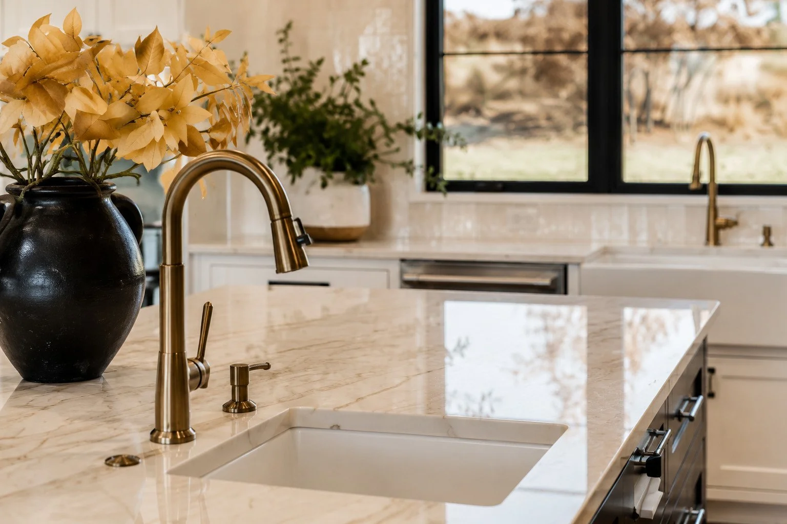 Kitchen counter with bronze faucet and marble backsplash, Franktown, Colorado