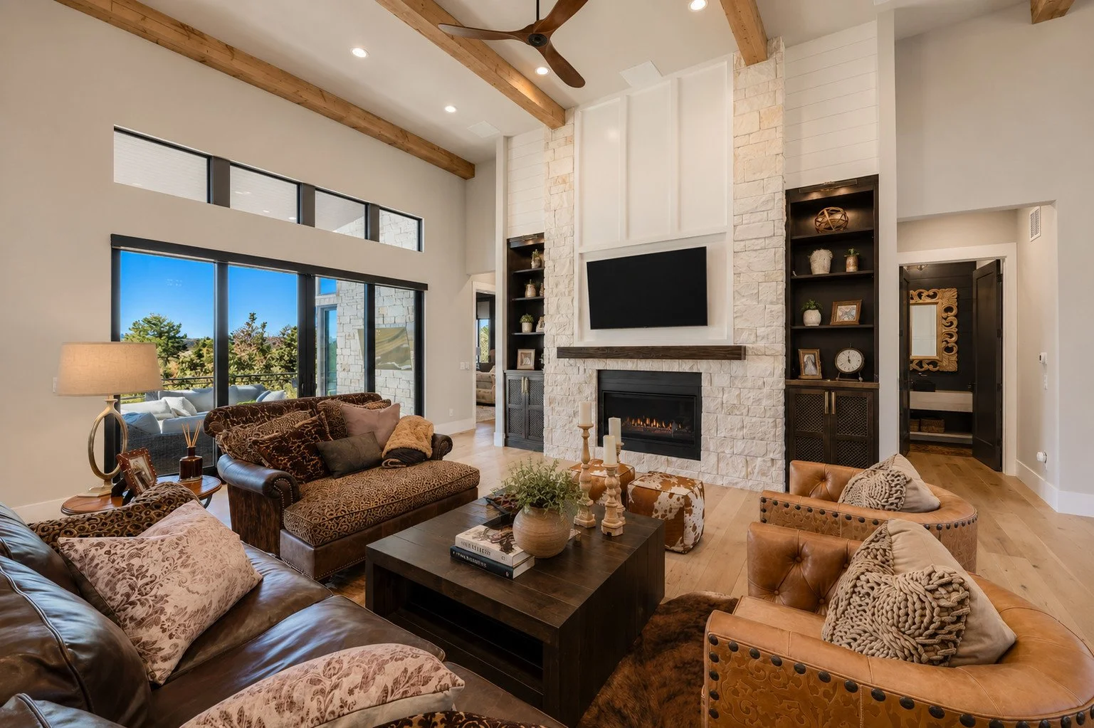 Great room with wood beam ceiling and stone fireplace, Franktown, Colorado