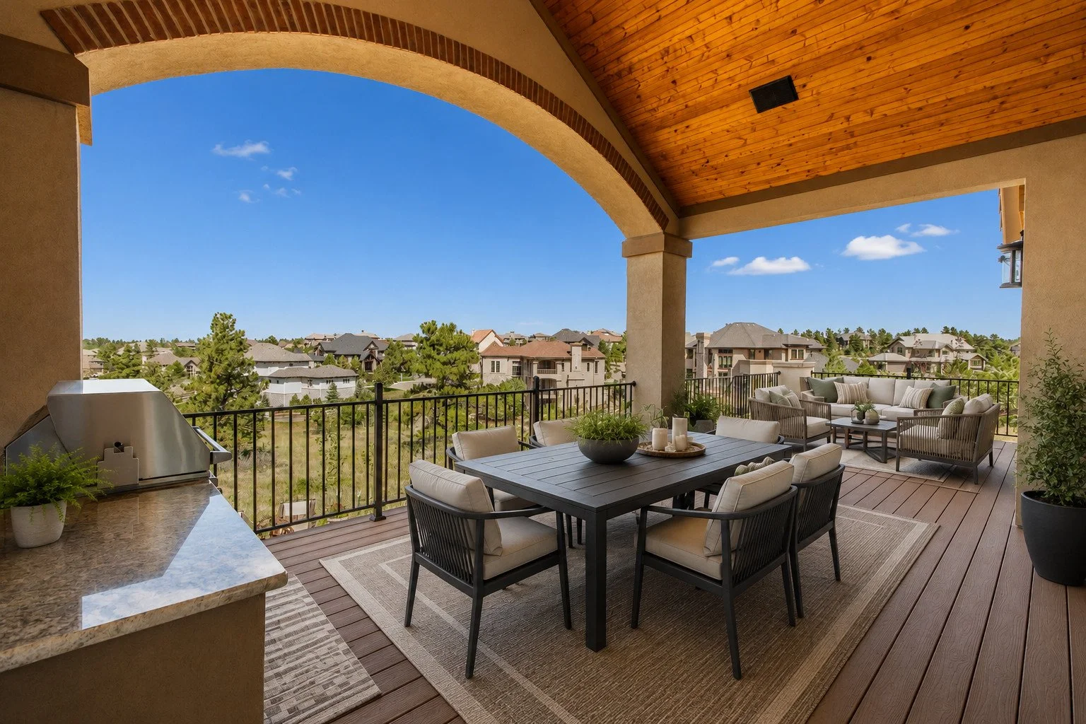 Custom upper-level covered outdoor living area with dining space and neighborhood views, Castle Rock, Colorado