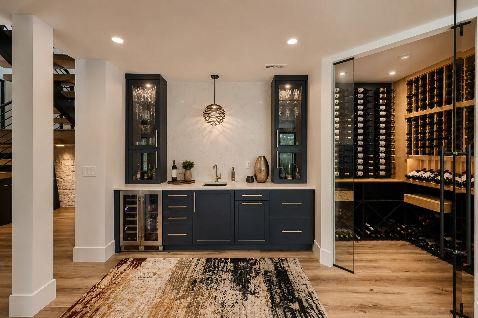 Wine bar with dark blue cabinets and glass storage, Franktown, Colorado