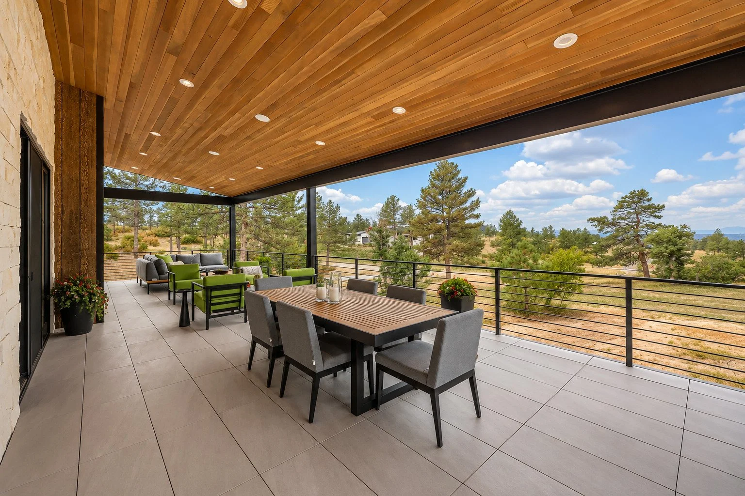 Custom covered outdoor living and dining area overlooking wooded Colorado landscape, Franktown, Colorado