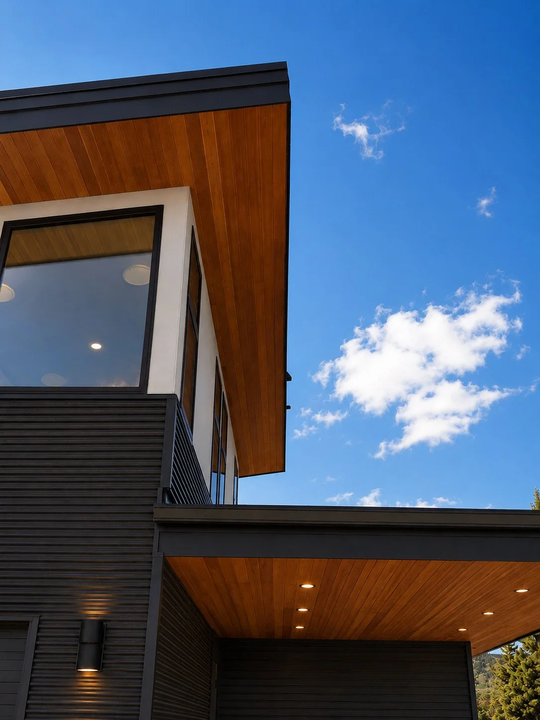 Architectural detail with large windows, horizontal metal siding, and shiplap wood soffits, Sedalia, Colorado