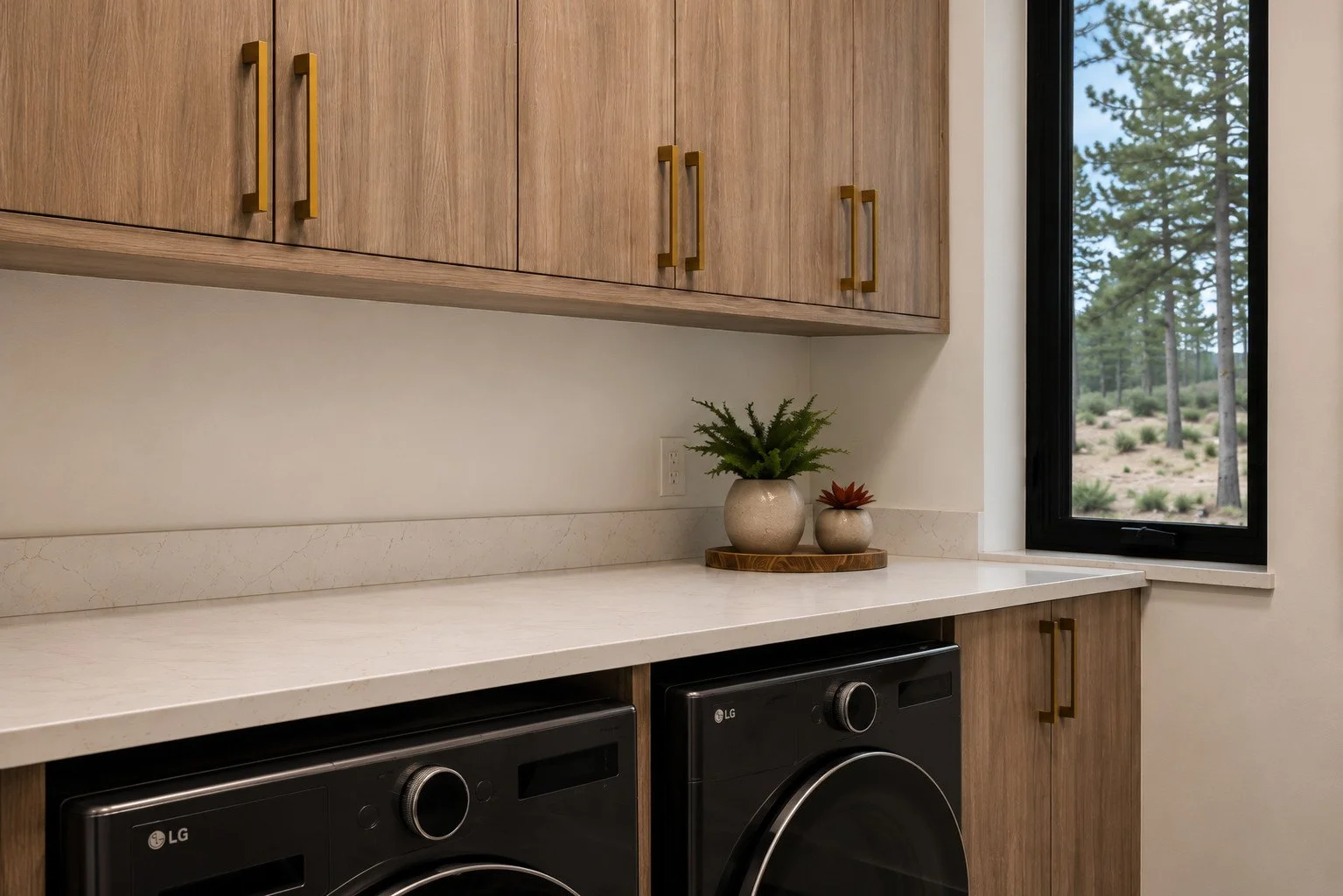 Laundry room with walnut cabinets, white counter, and  black appliances, Franktown, Colorado