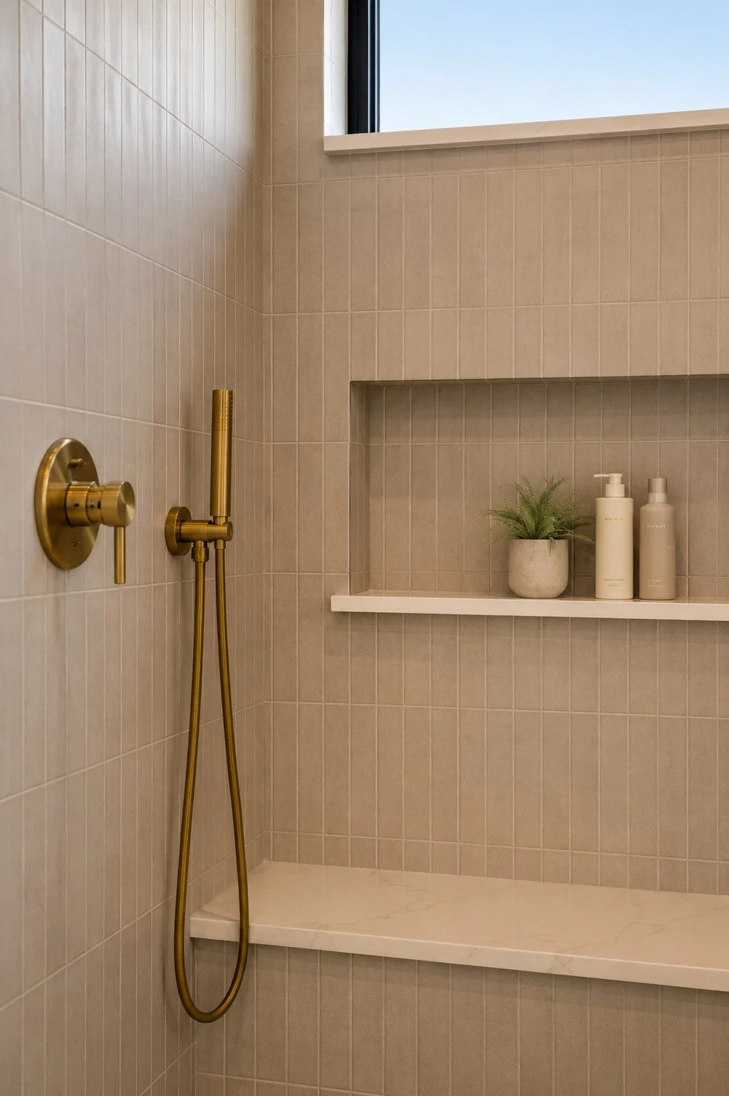 Spa-style shower with brass showerhead and custom shampoo niche, Parker, Colorado