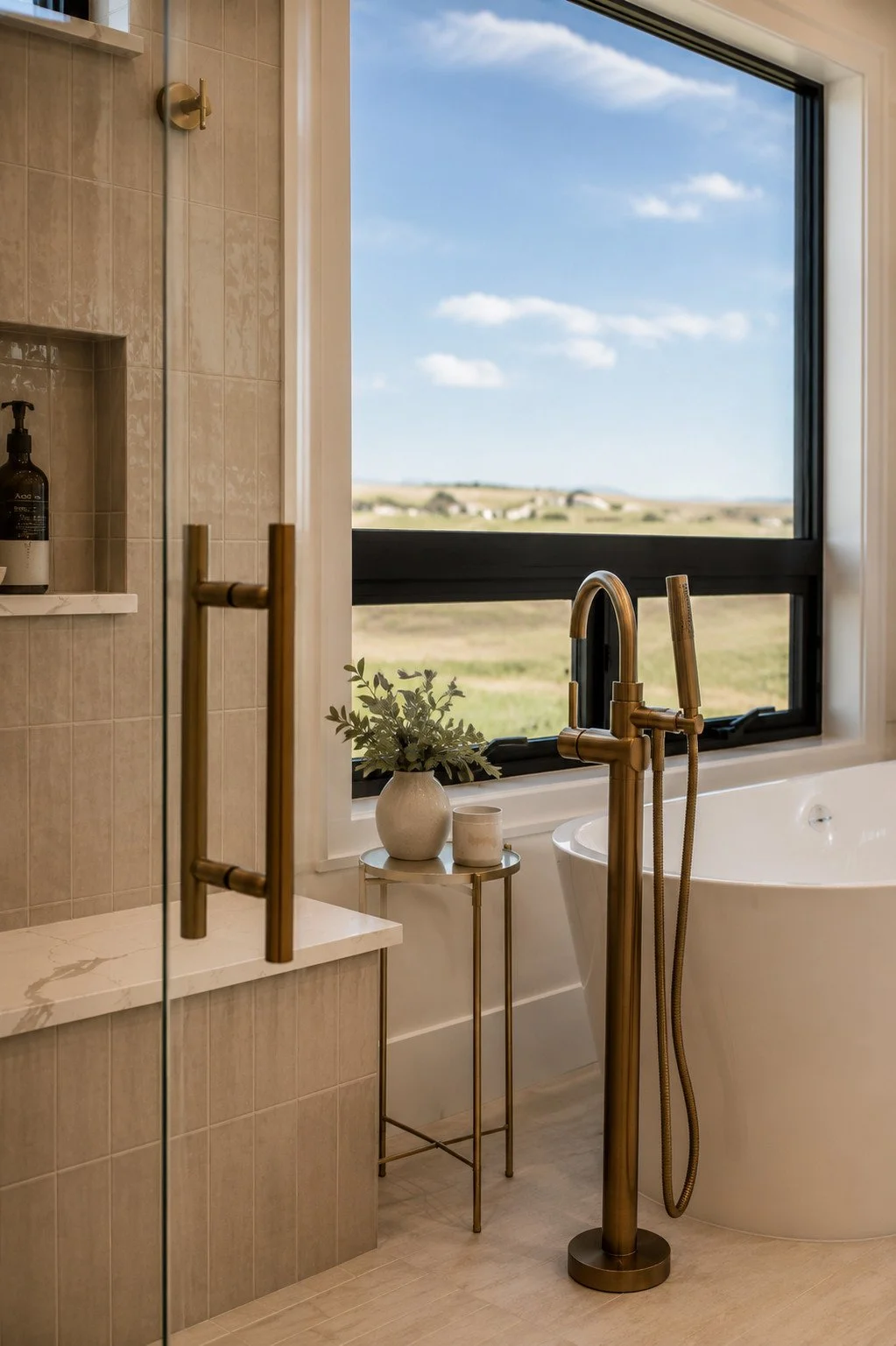 Freestanding tub with brass faucet by picture window, Parker, Colorado