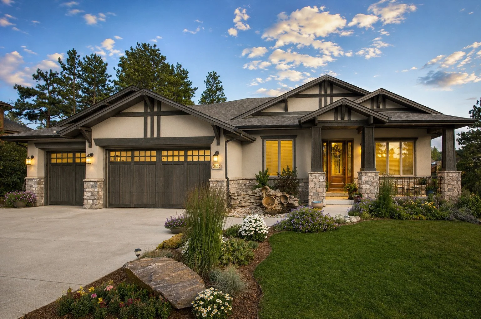 Modern craftsman home with stone accents, dark wood garage doors, a front porch, Castle Rock, Colorado
