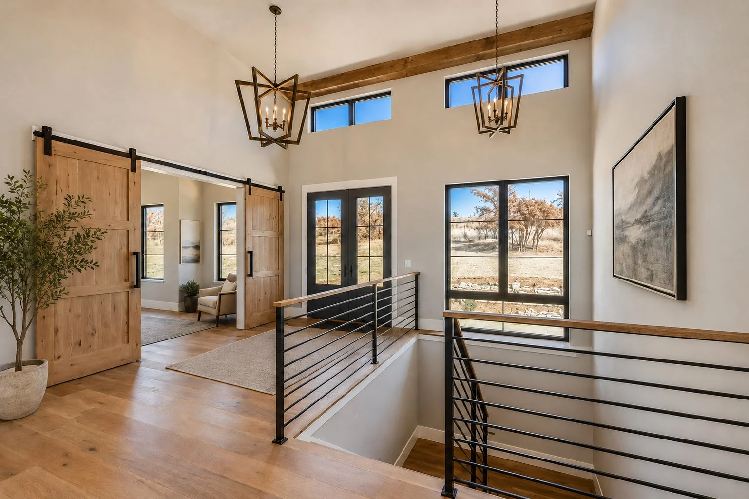 modern house with a staircase, large windows, hanging light fixtures, a sliding barn door, Franktown, Colorado