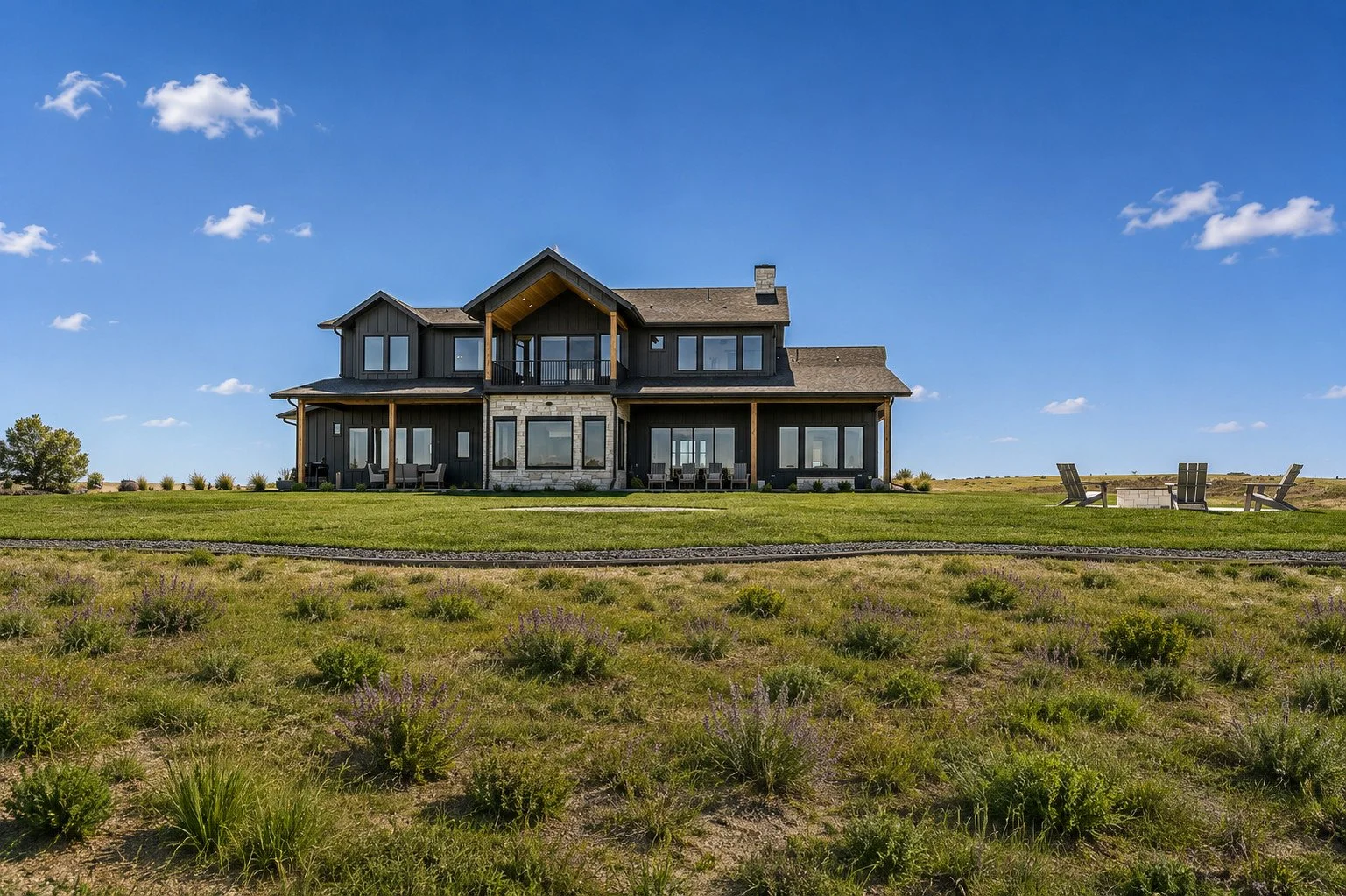 Rear elevation of modern Colorado custom home with dark siding and expansive windows, Parker, Colorado