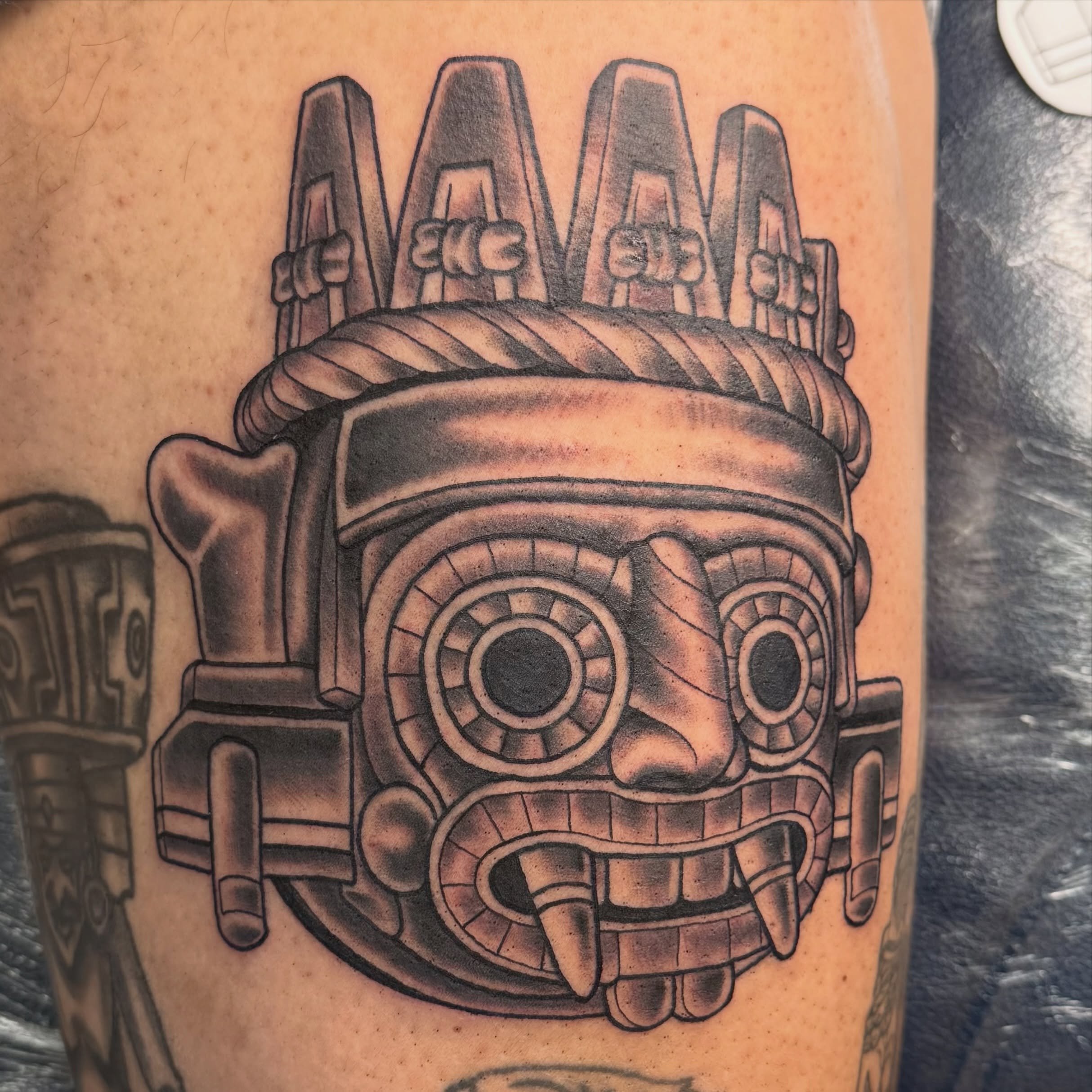 This tattoo is based off a monolith of Tl&aacute;loc Aztec deity of rain, water and fertility.
