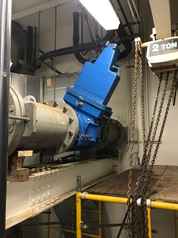 14 inch valve insertion in the ceiling inside a sewer treatment plant.