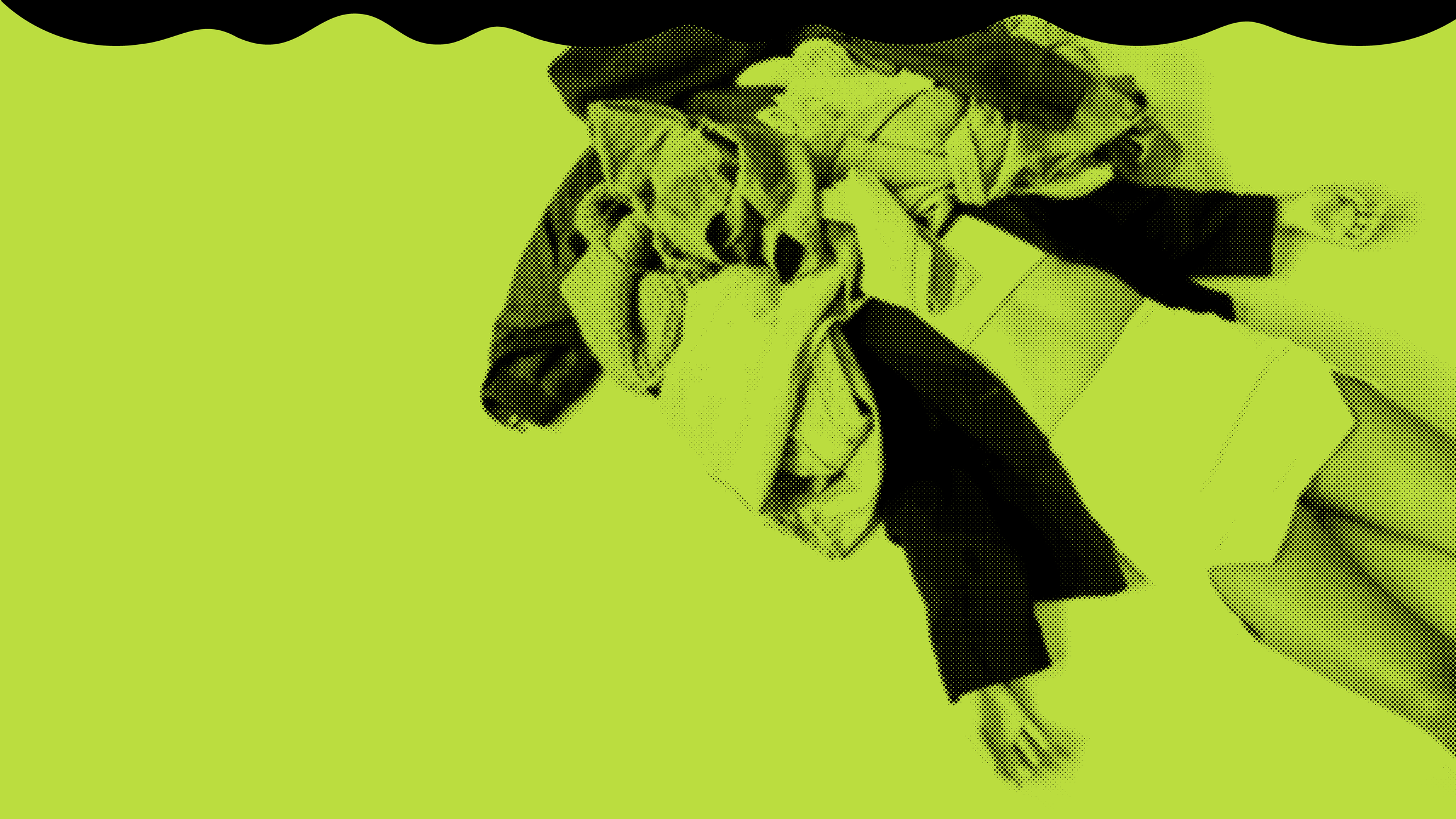 person laying on ground with a large pile of clothes over their head