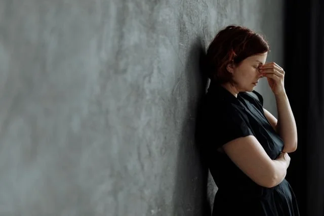 woman leaning on wall