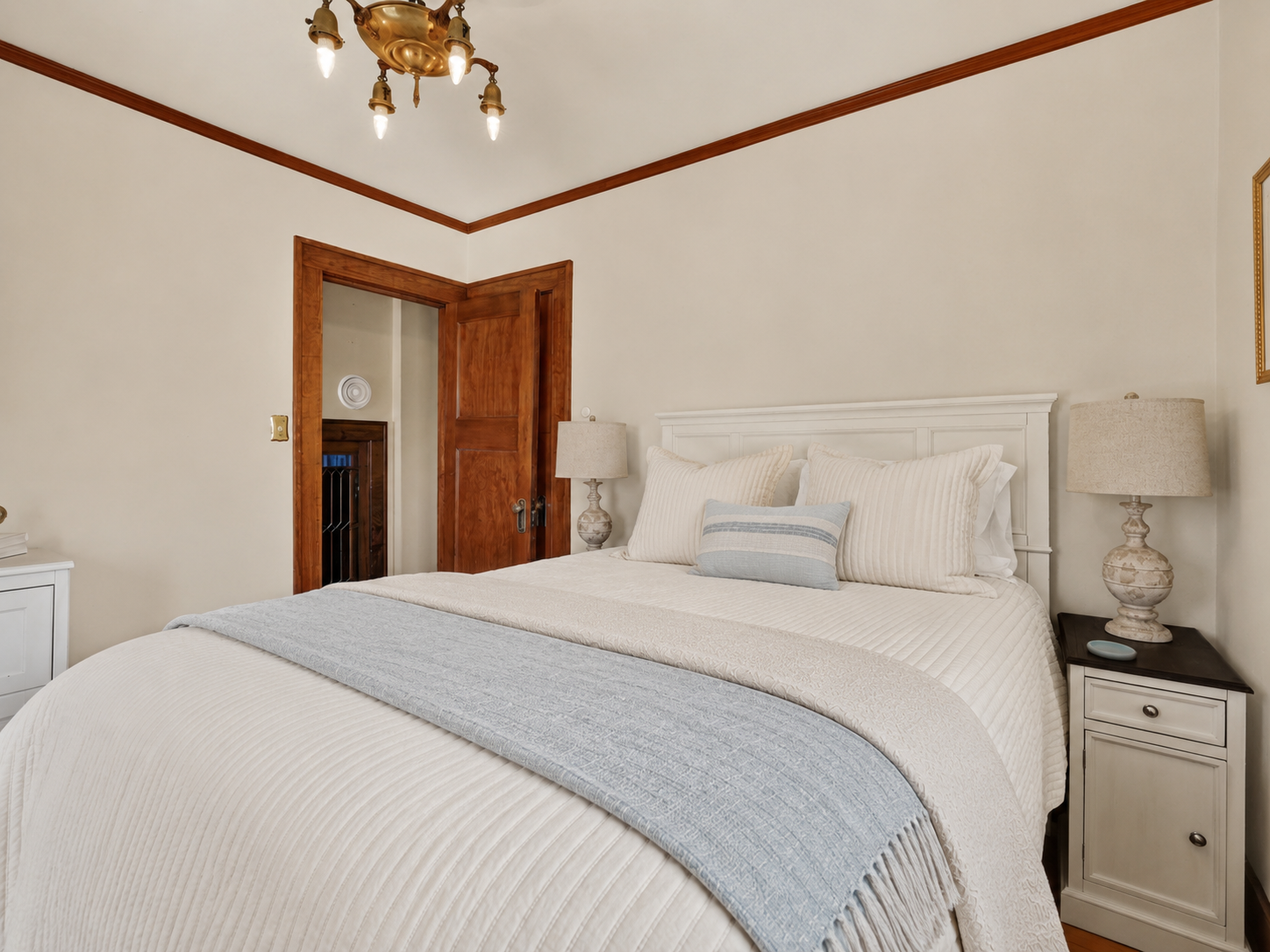 Comfortable private bedroom with premium bedding and workspace