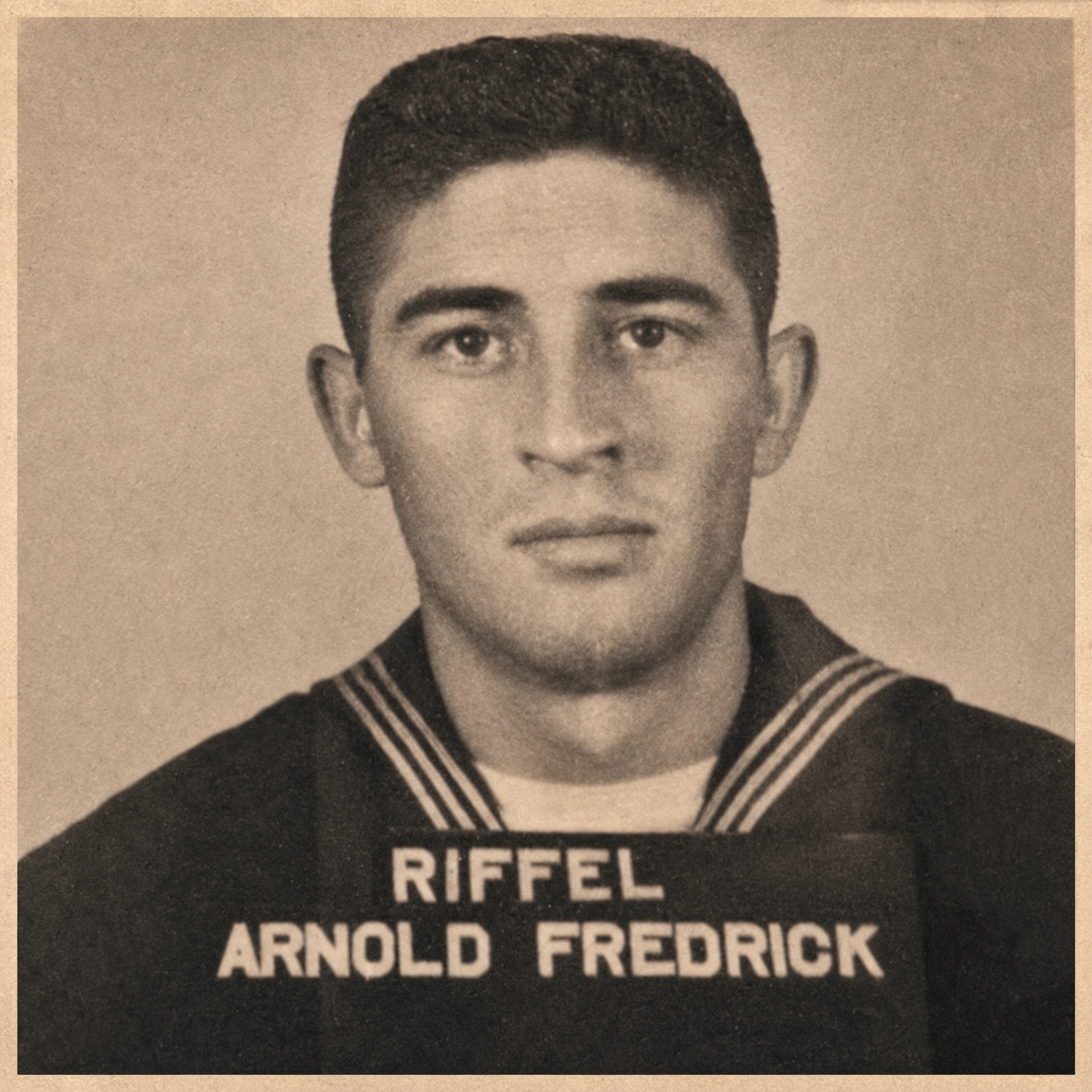 Black and white portrait of a young man in a military or naval uniform with the name tag 'Riffel Arnold Fredrick'.