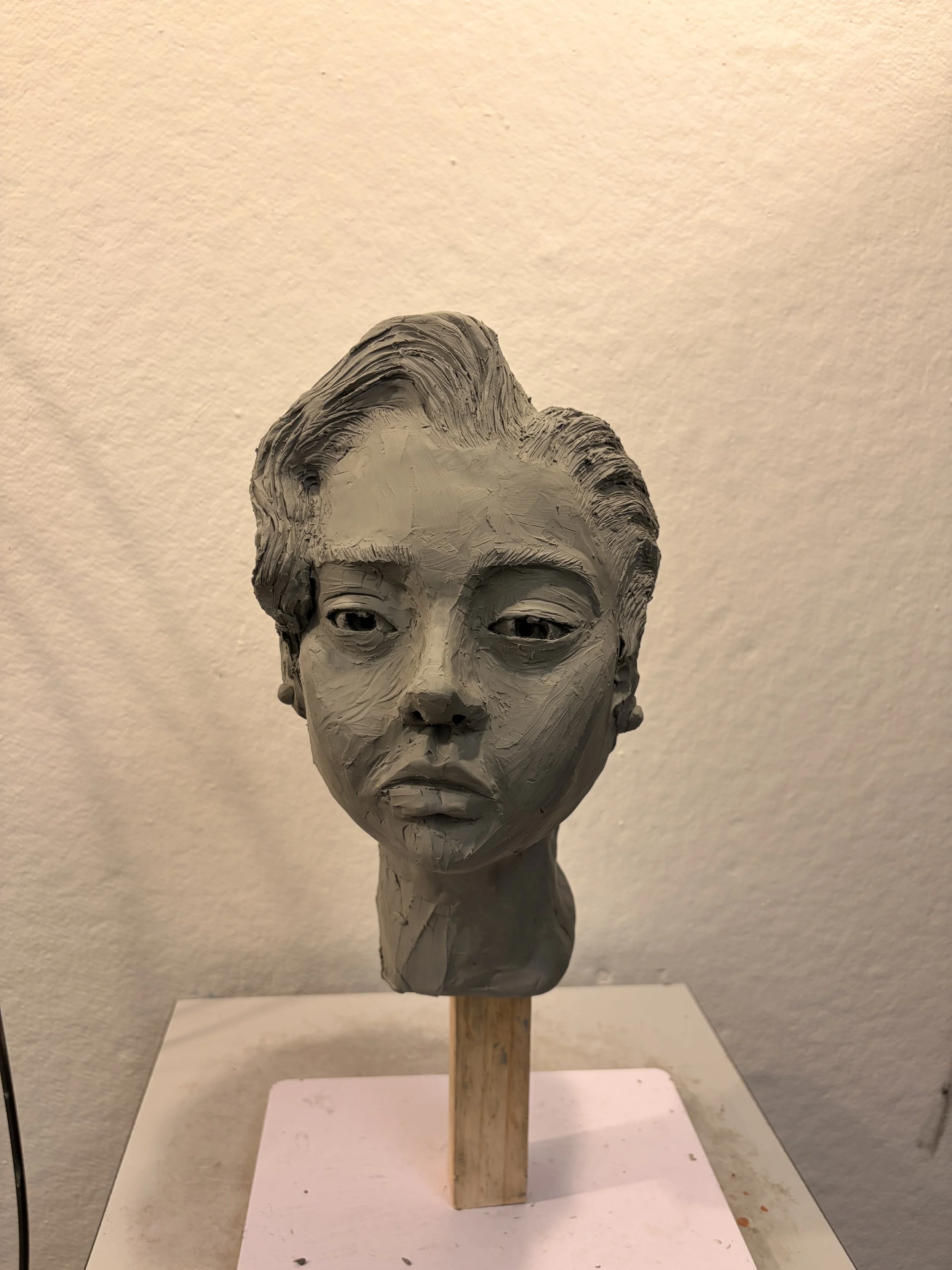 Woman's sculpted head; from observation and my own drawing references - oil based clay (2026)