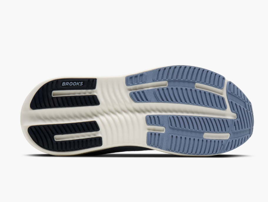 Close-up of the bottom of a Brooks running shoe showing the tread pattern with black, white, and gray sections.